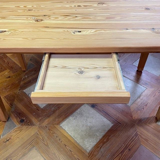 a wooden table with a drawer