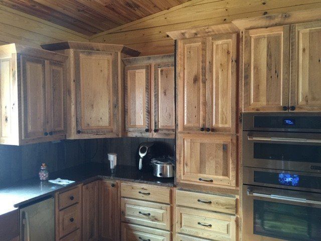 a kitchen with wooden cabinets and stainless steel appliances