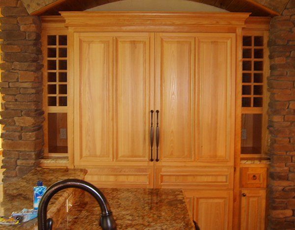 a kitchen with wooden cabinets and a granite counter top