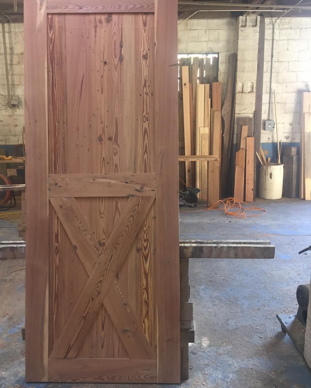 a wooden door is sitting in a room with a lot of wood