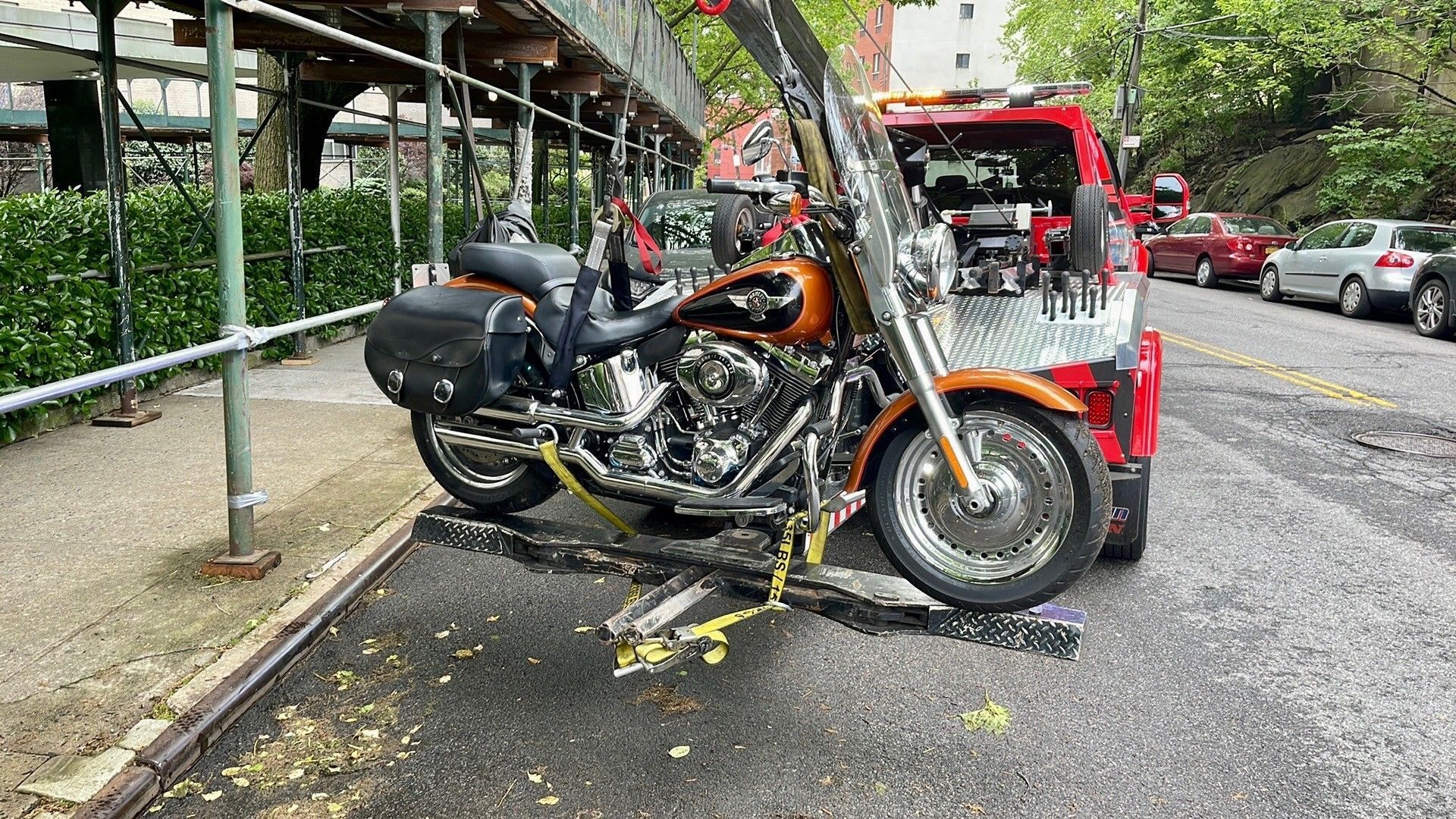 A motorcycle is being towed by a tow truck.