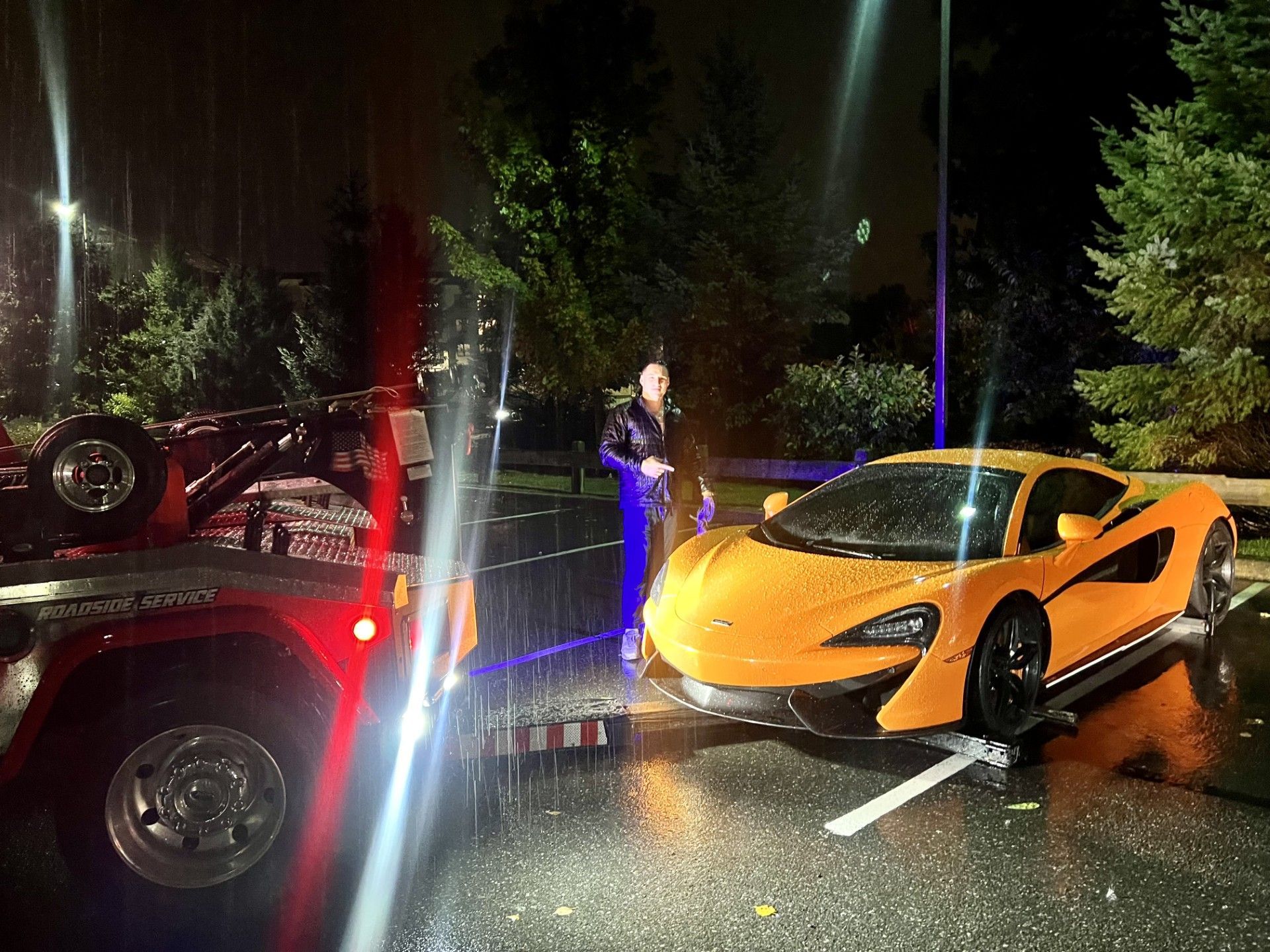 A yellow sports car is being towed by a tow truck