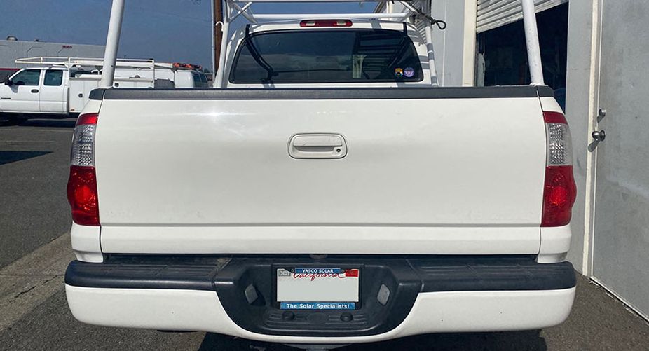 The back of a white truck with a license plate that says california