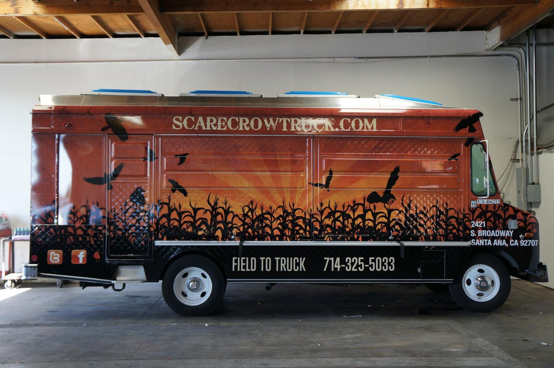 A scarecrow truck is parked in a garage