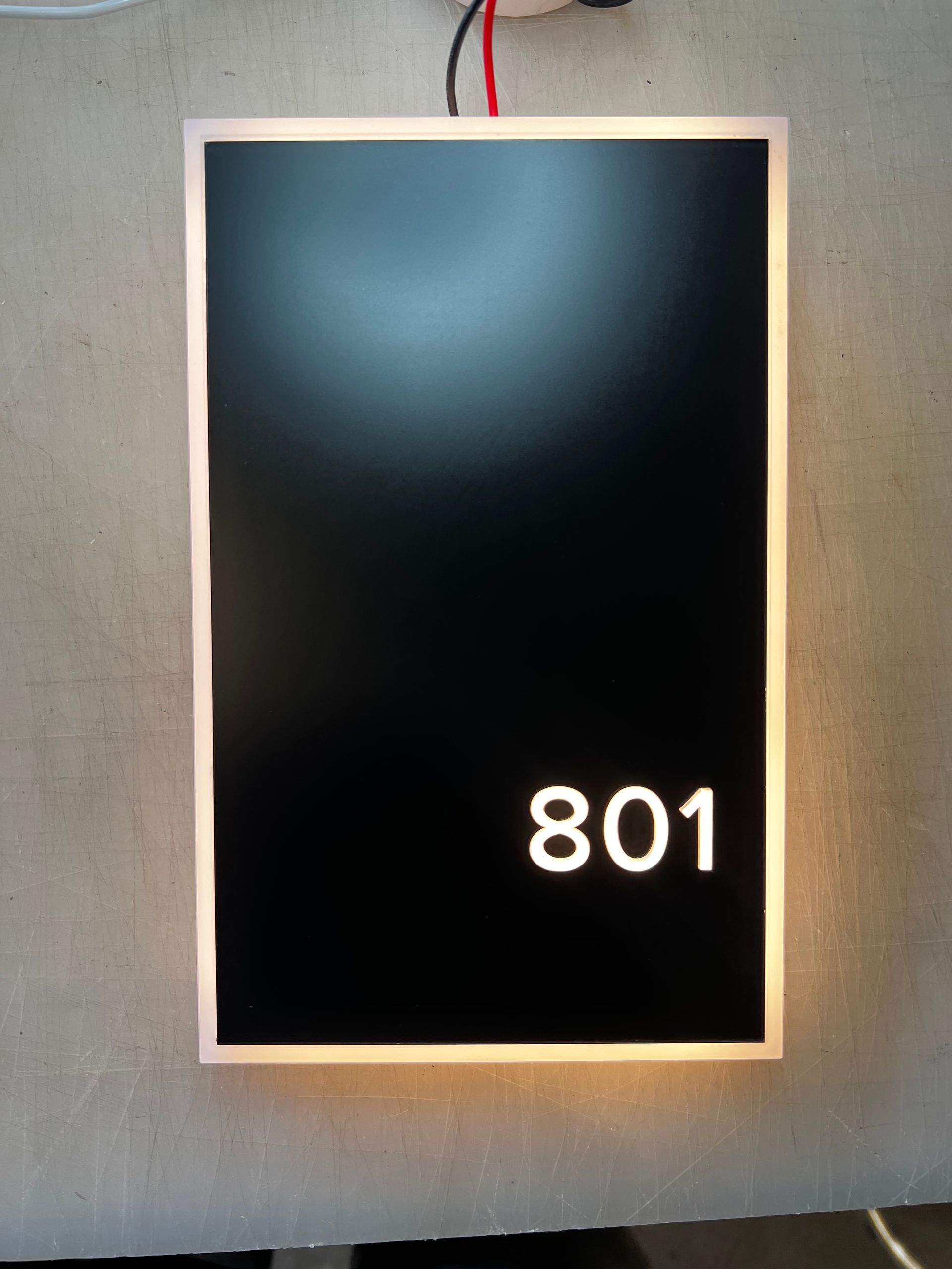 A black sign with the number 801 on it