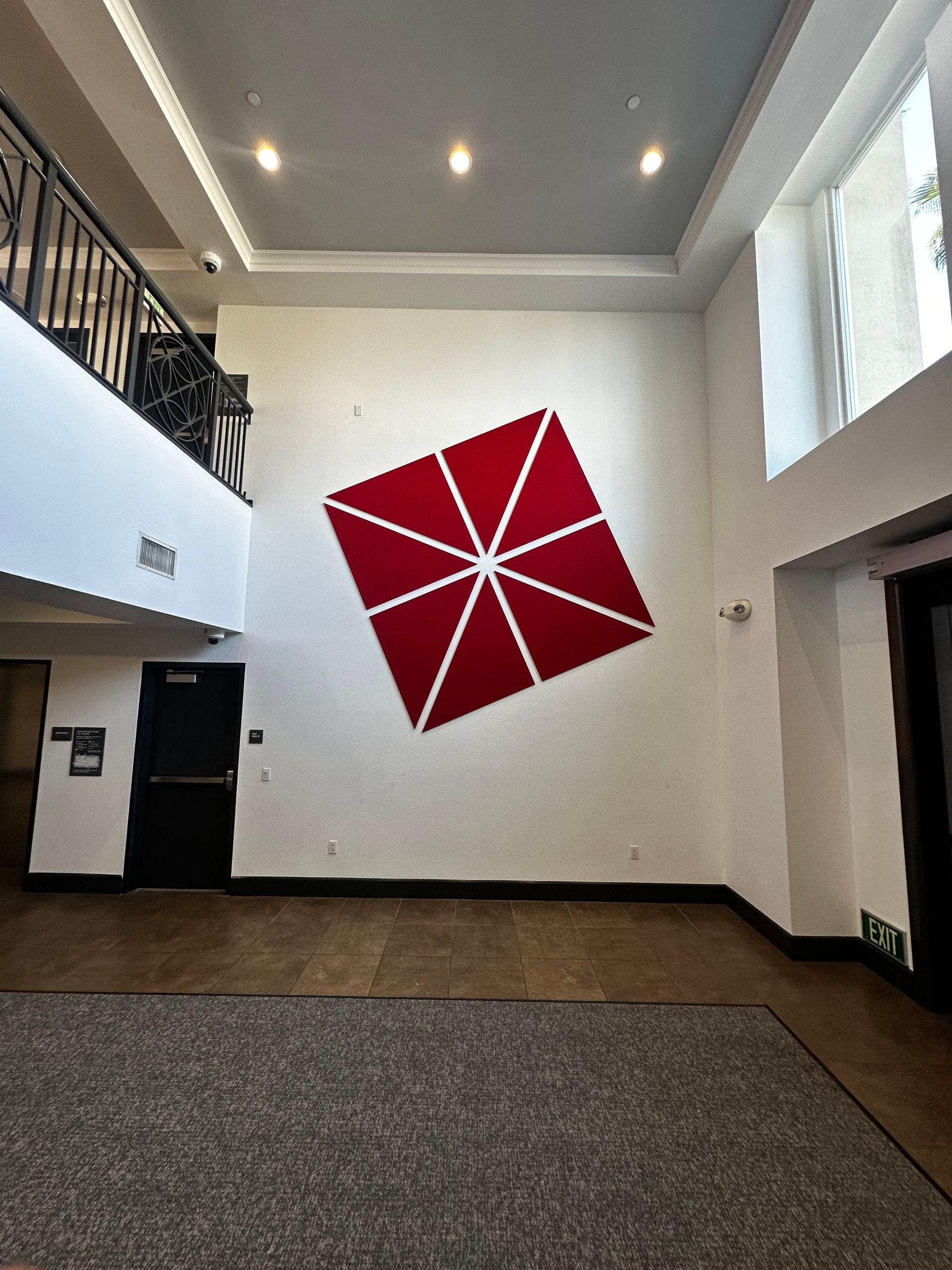 An empty room with a large red square on the wall