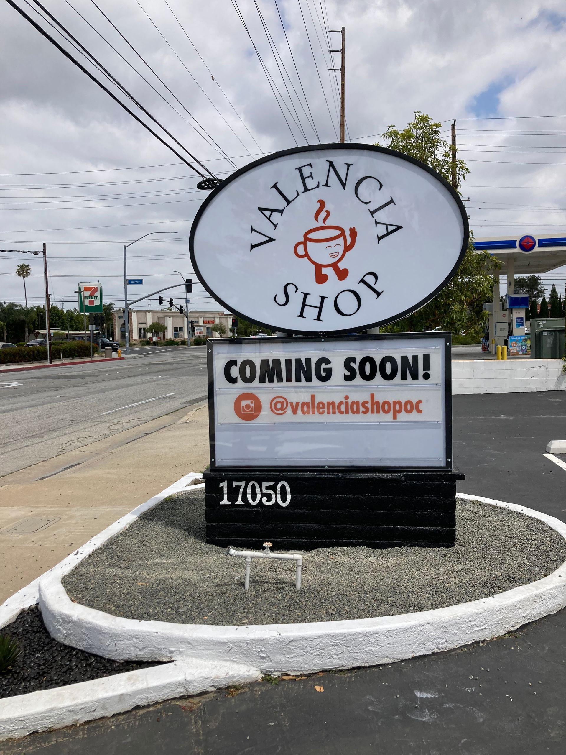 A sign that says valencia shop coming soon