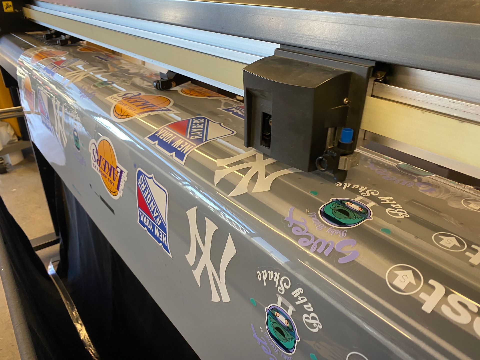 A machine that is printing stickers on a piece of paper