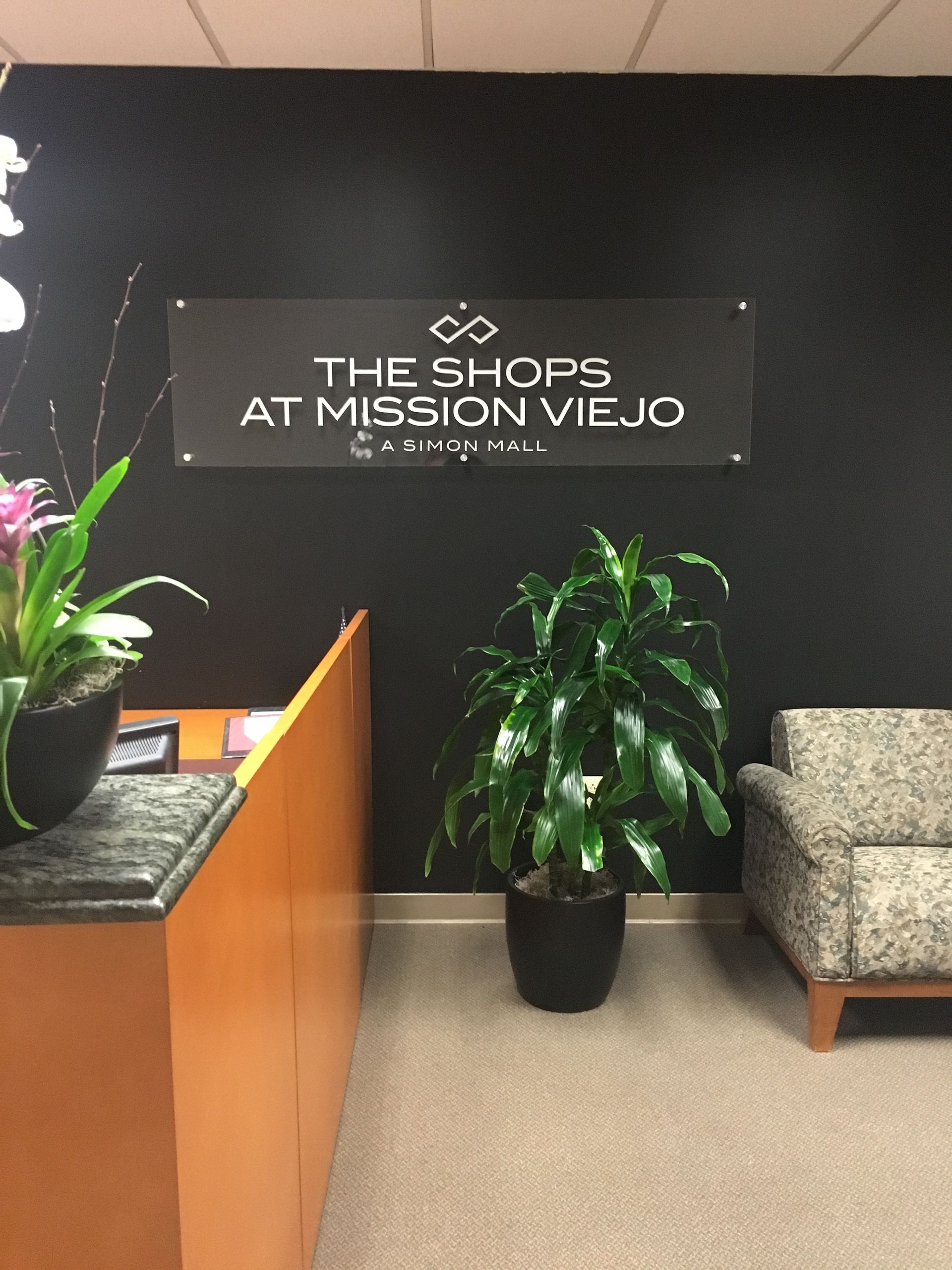 A sign that says the shops at mission viejo on it