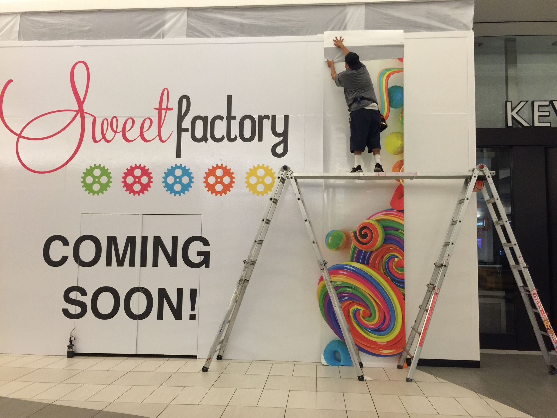 A sweet factory sign that is coming soon