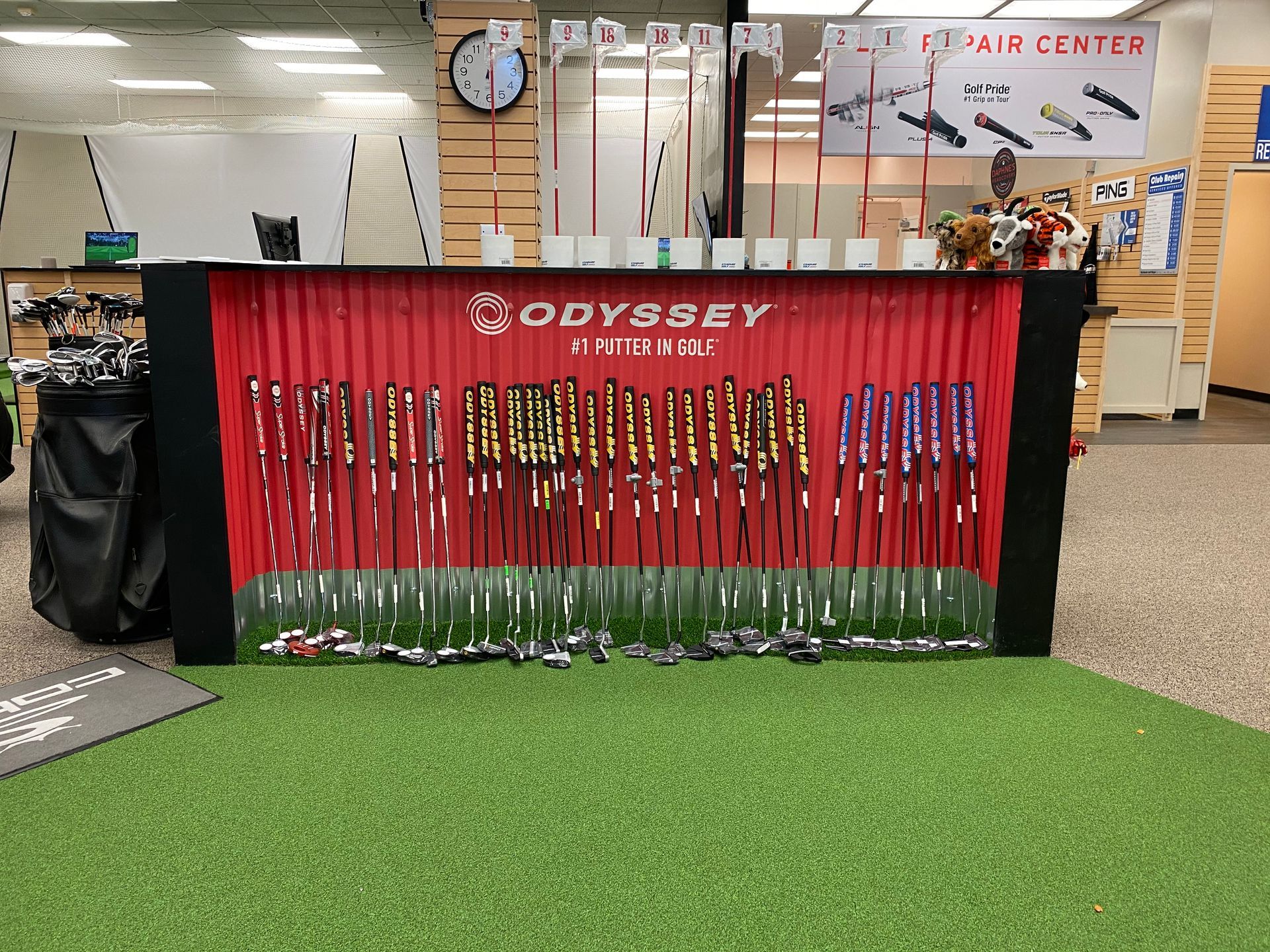A display of golf clubs in a store called odyssey