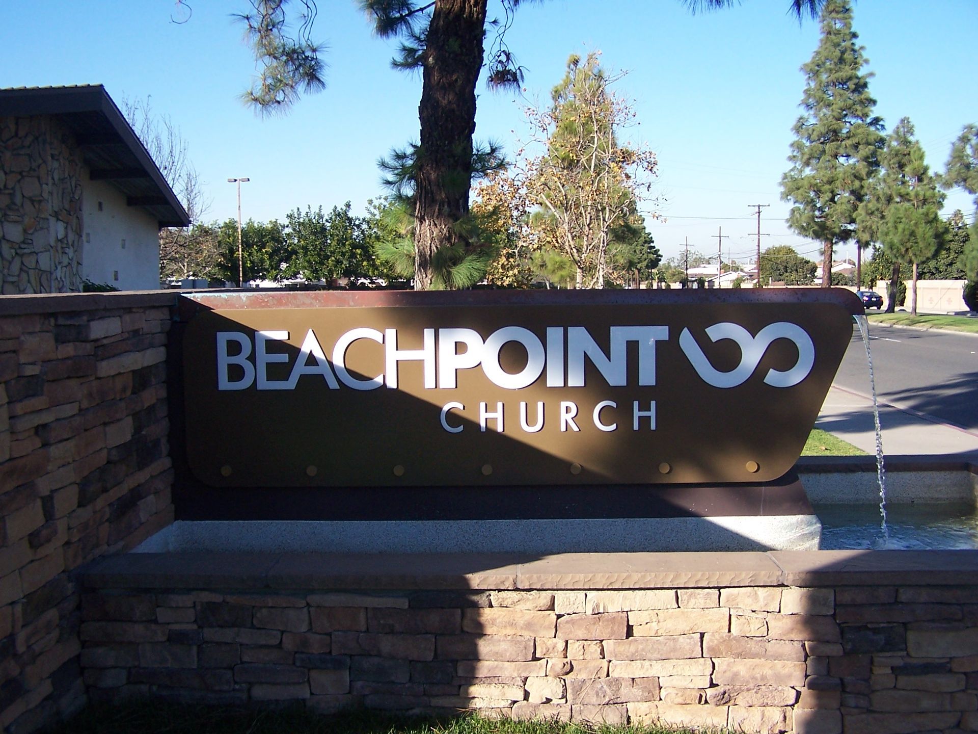 A sign that says beachpoint church on it