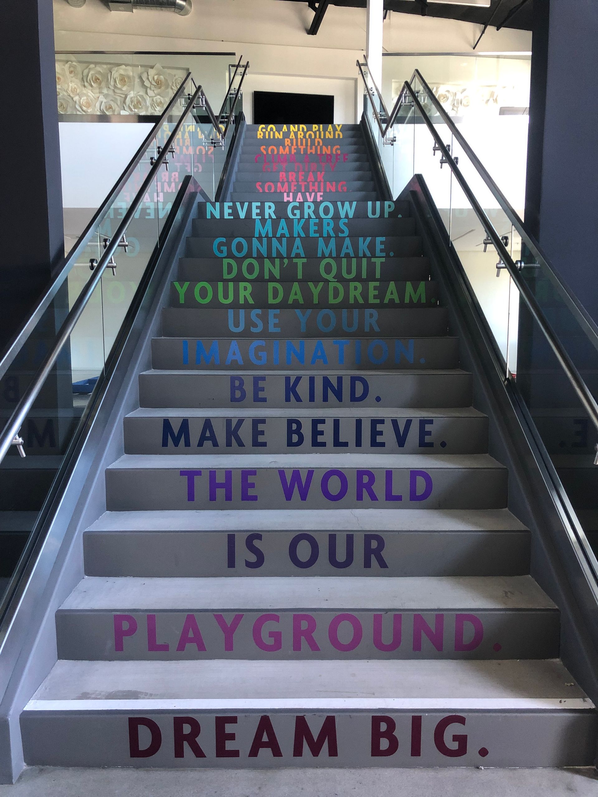 A set of stairs with a quote on them that says dream big