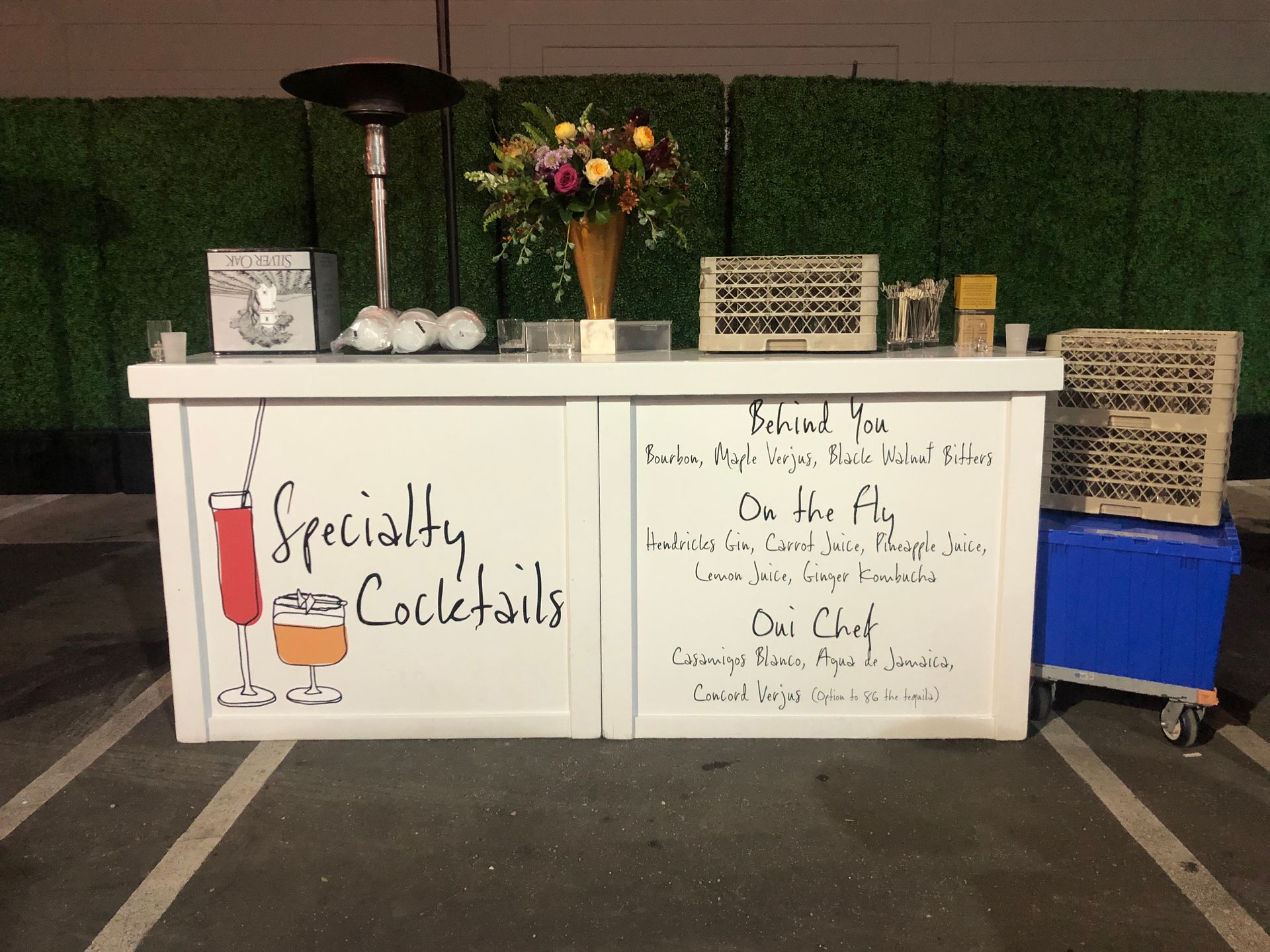 A white bar with specialty cocktails written on it