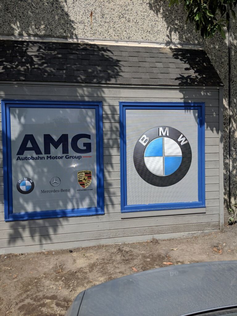 A bmw and amg sign is on the side of a building