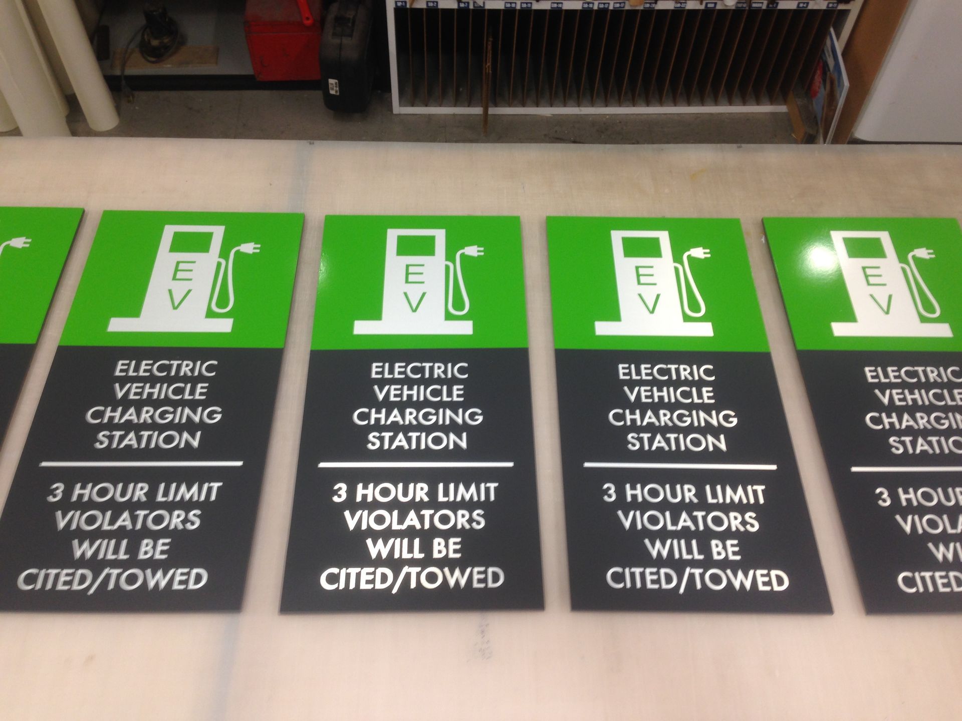 A row of signs for an electric vehicle charging station