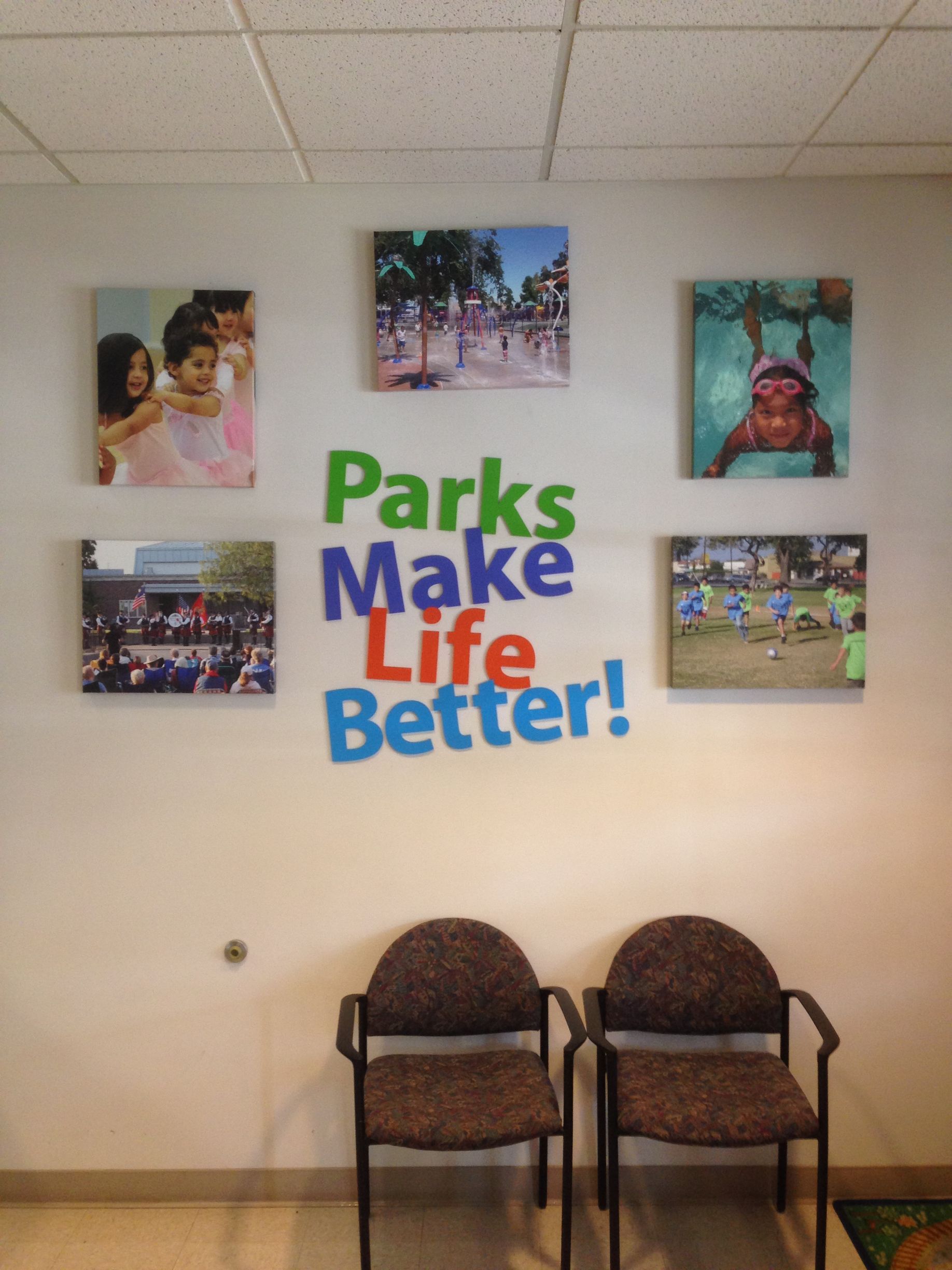 Two chairs in front of a wall that says parks make life better
