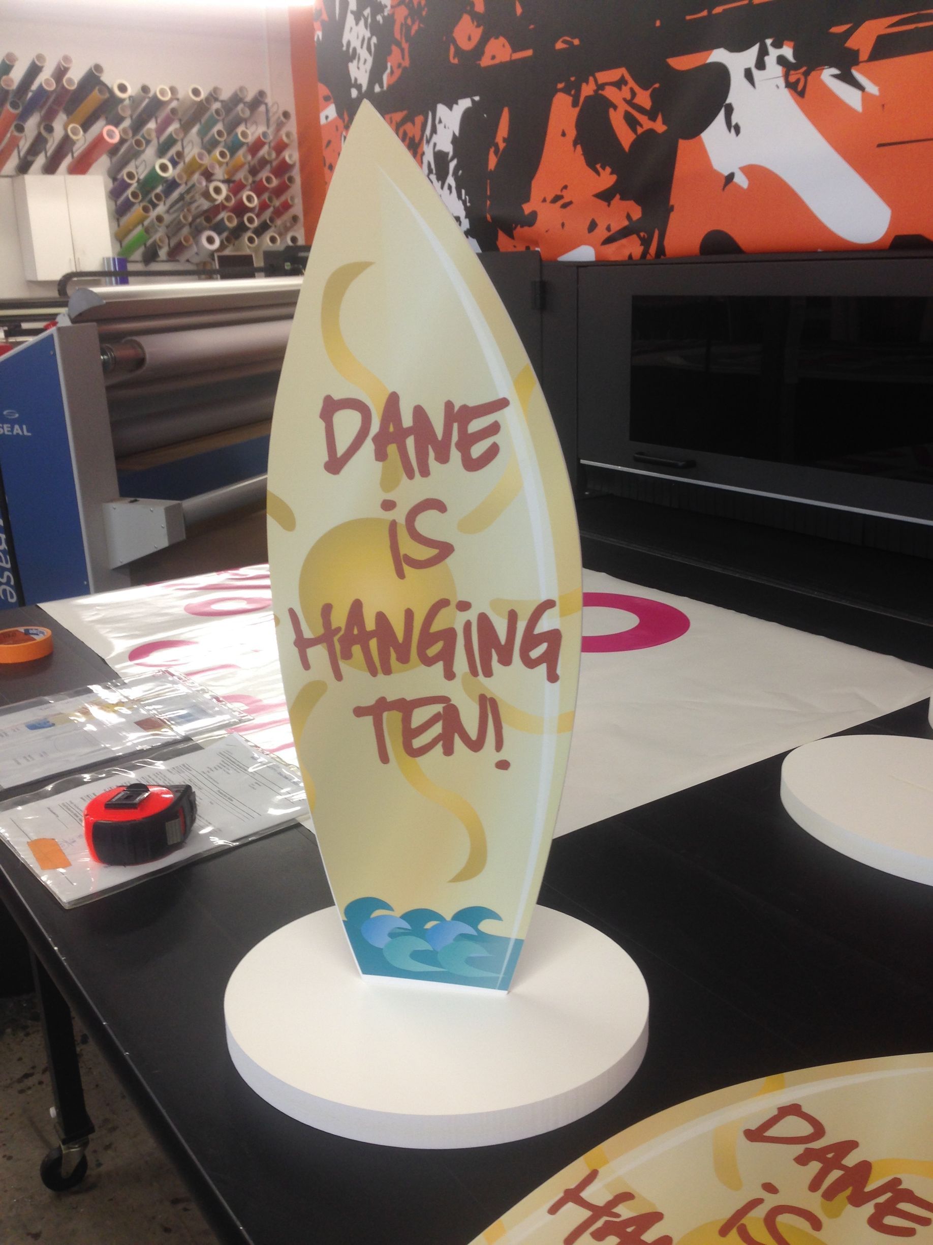 A sign that says dane is hanging ten