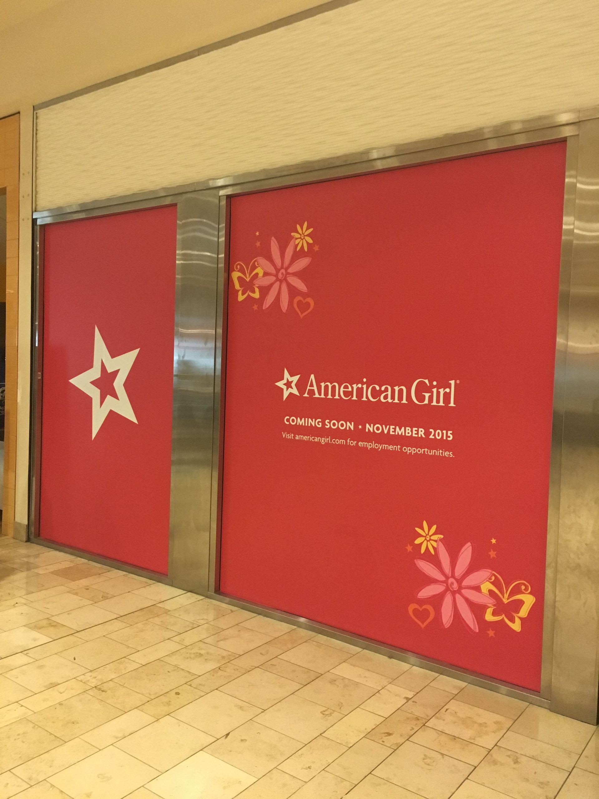 A store front with a sign that says american girl
