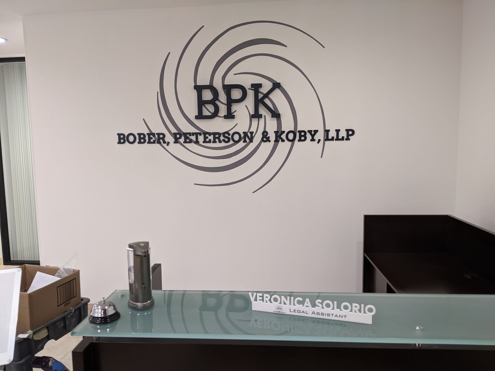 A sign on a wall that says bpk bober peterson & koby llp