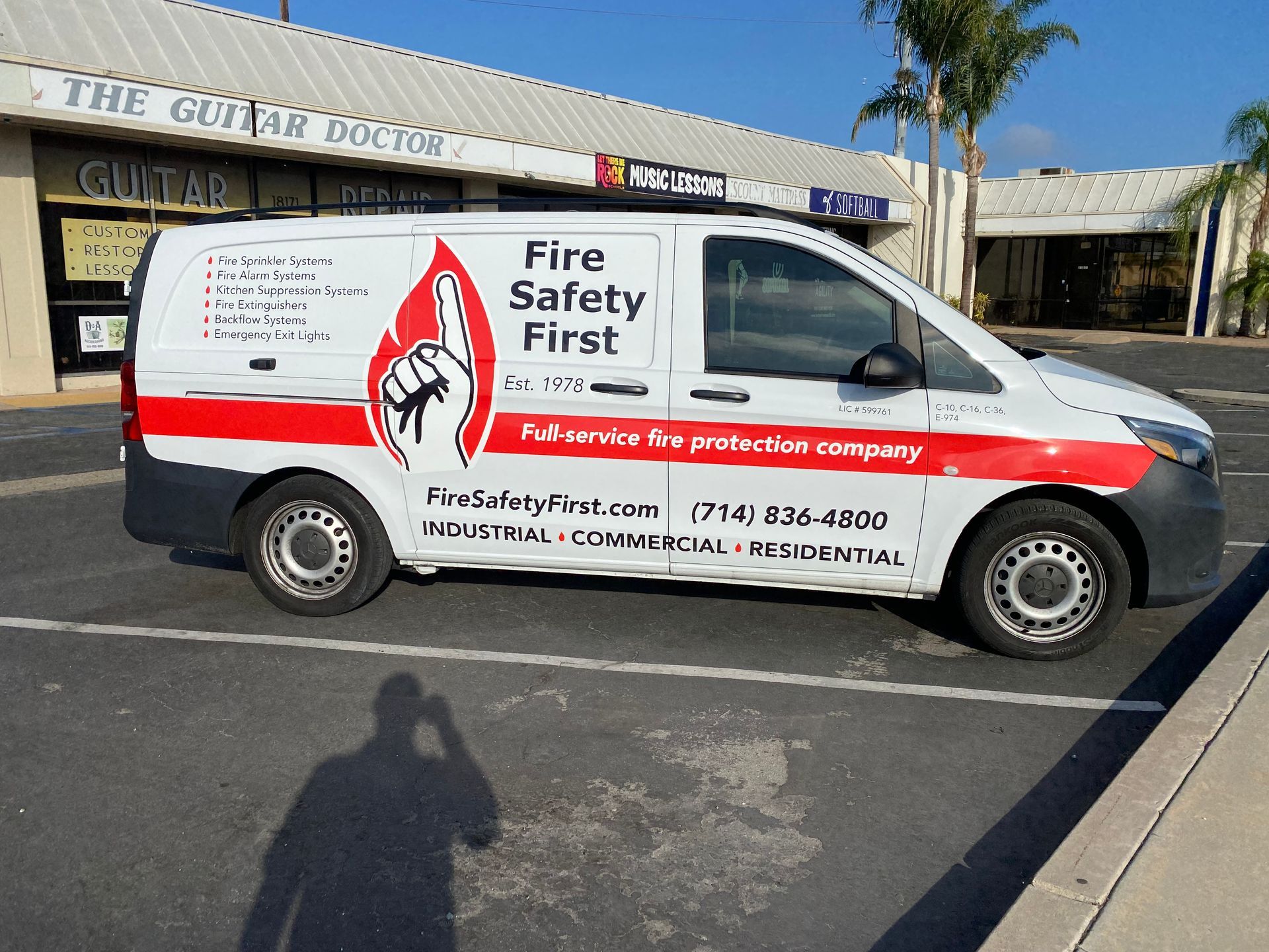 A fire safety first van is parked in a parking lot