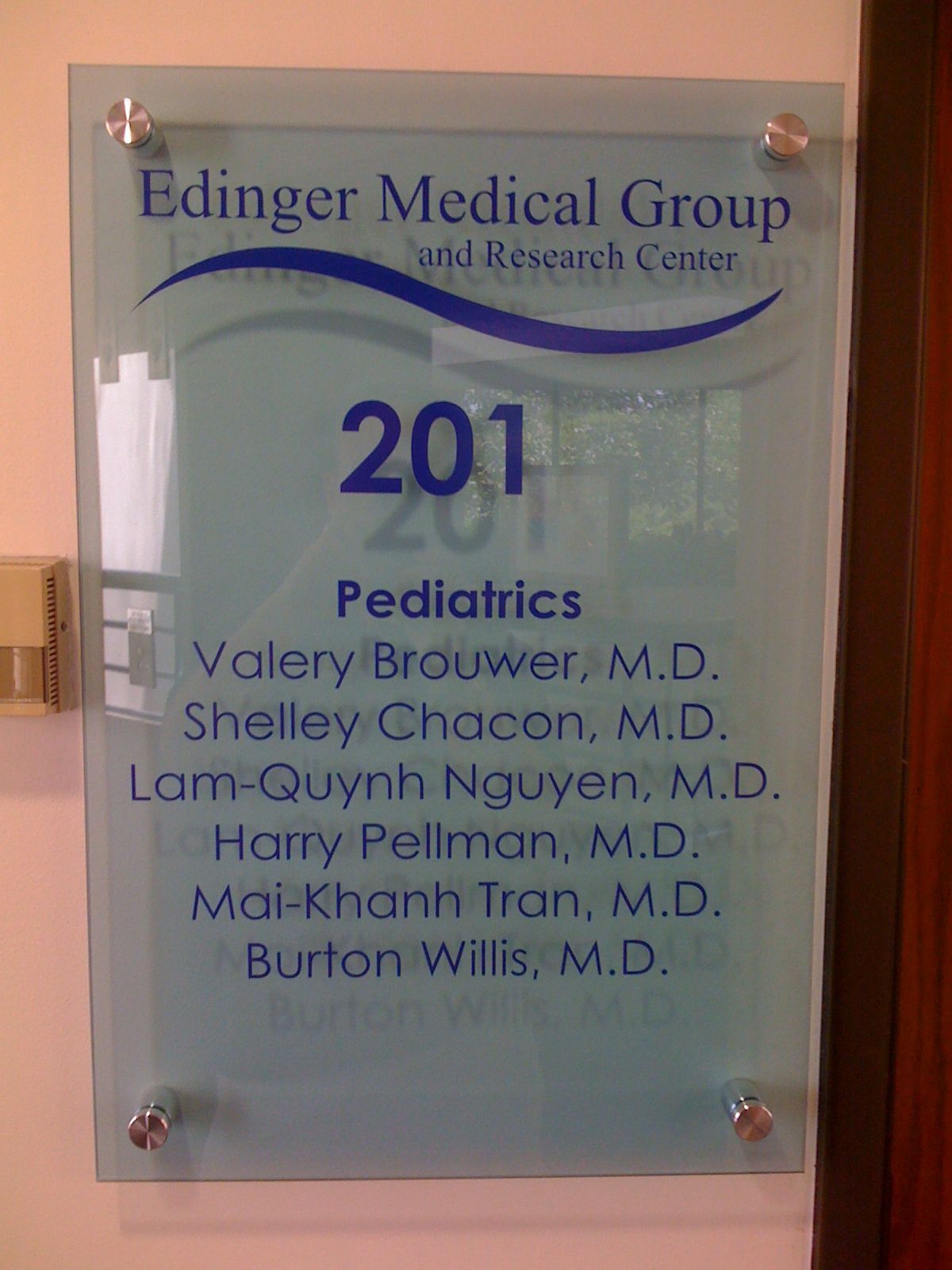 A glass sign for the ediinger medical group pediatrics
