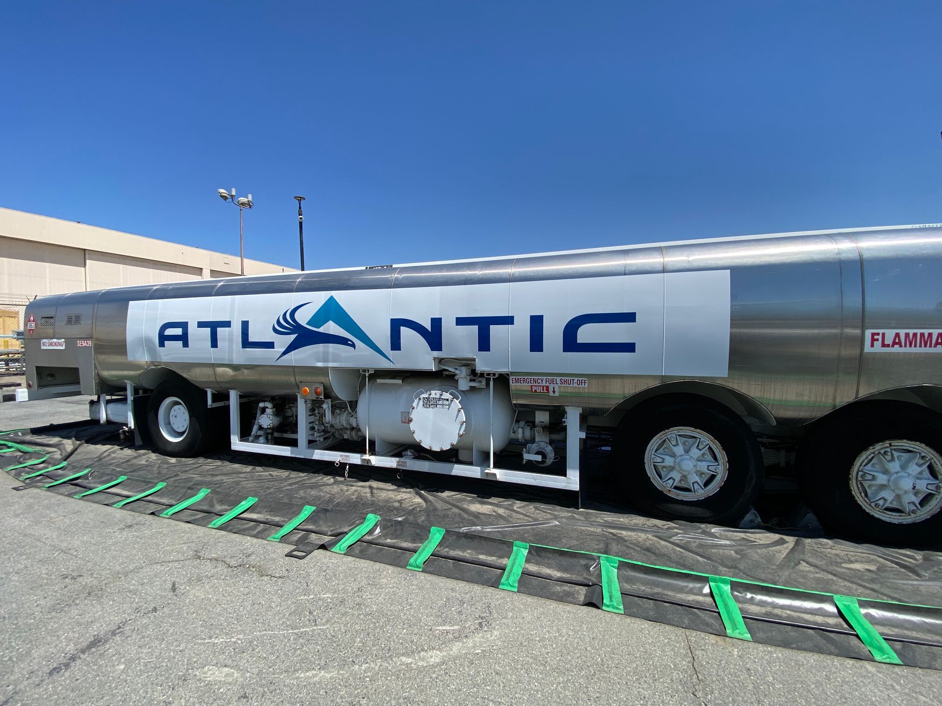 An atlantic tanker truck is parked on the side of the road