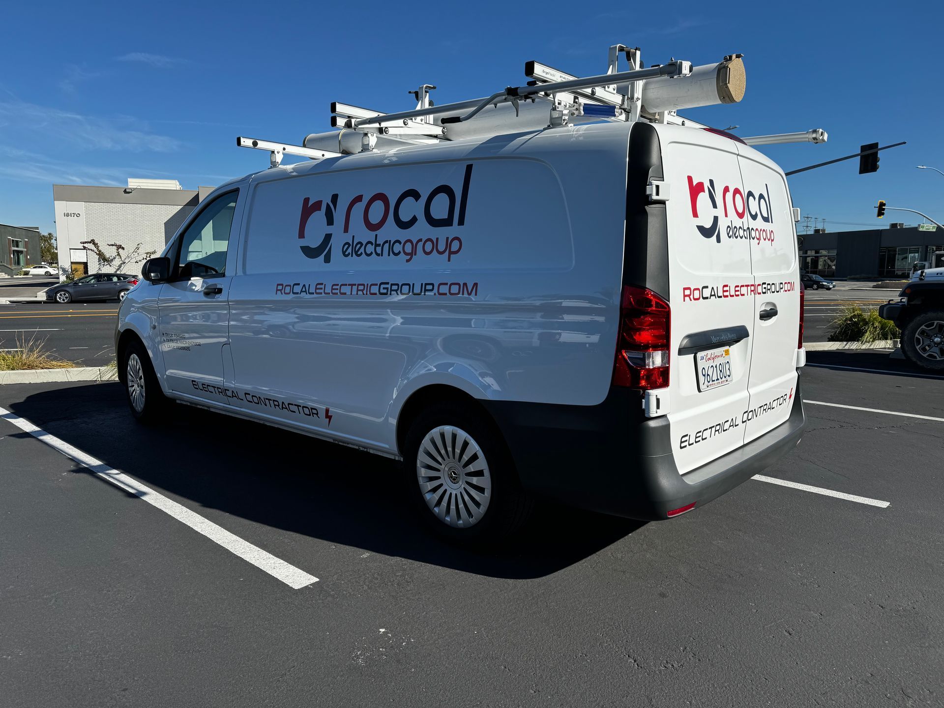 A white van is parked in a parking lot.