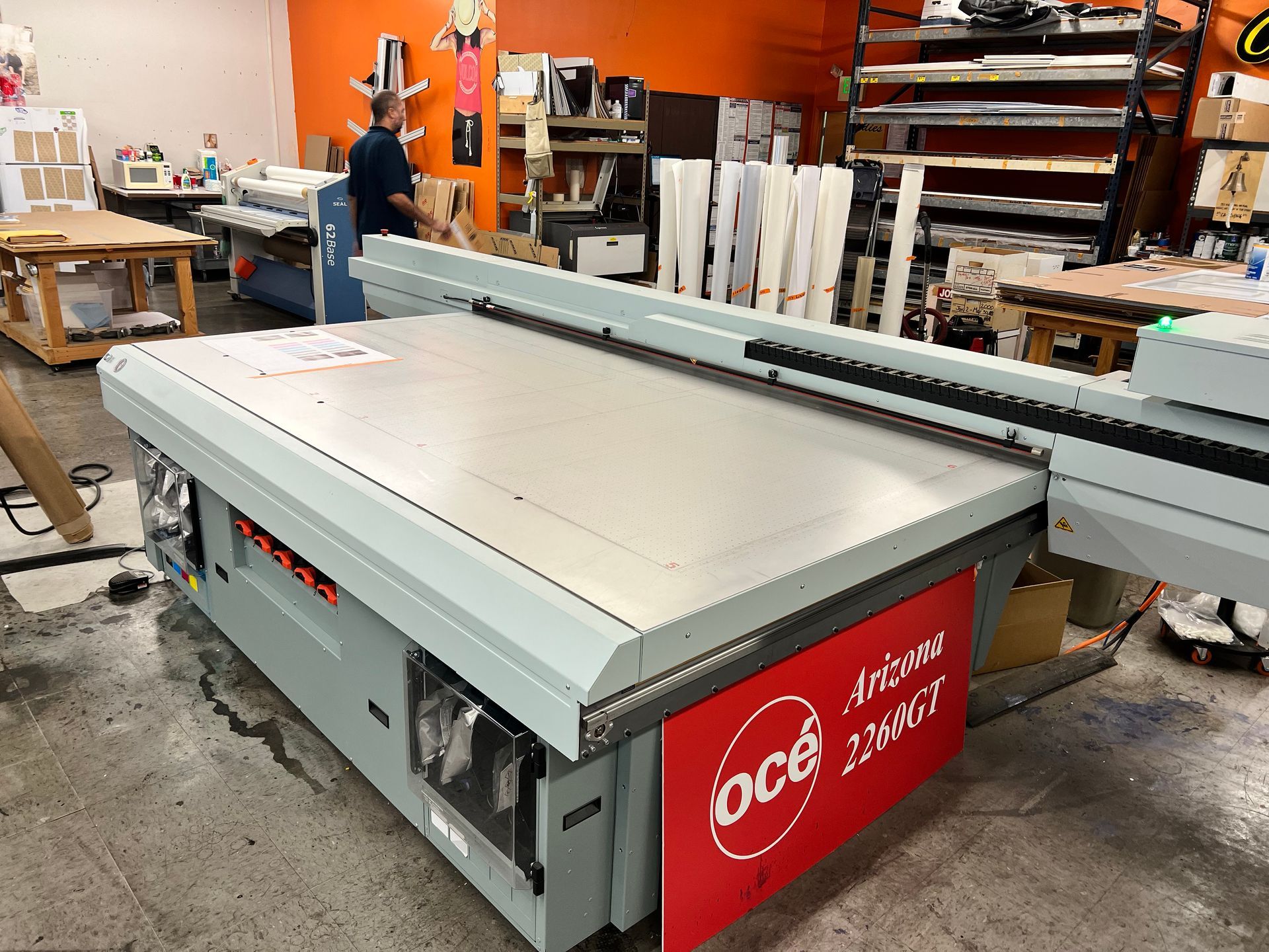 A large machine with a red sign that says oce on it