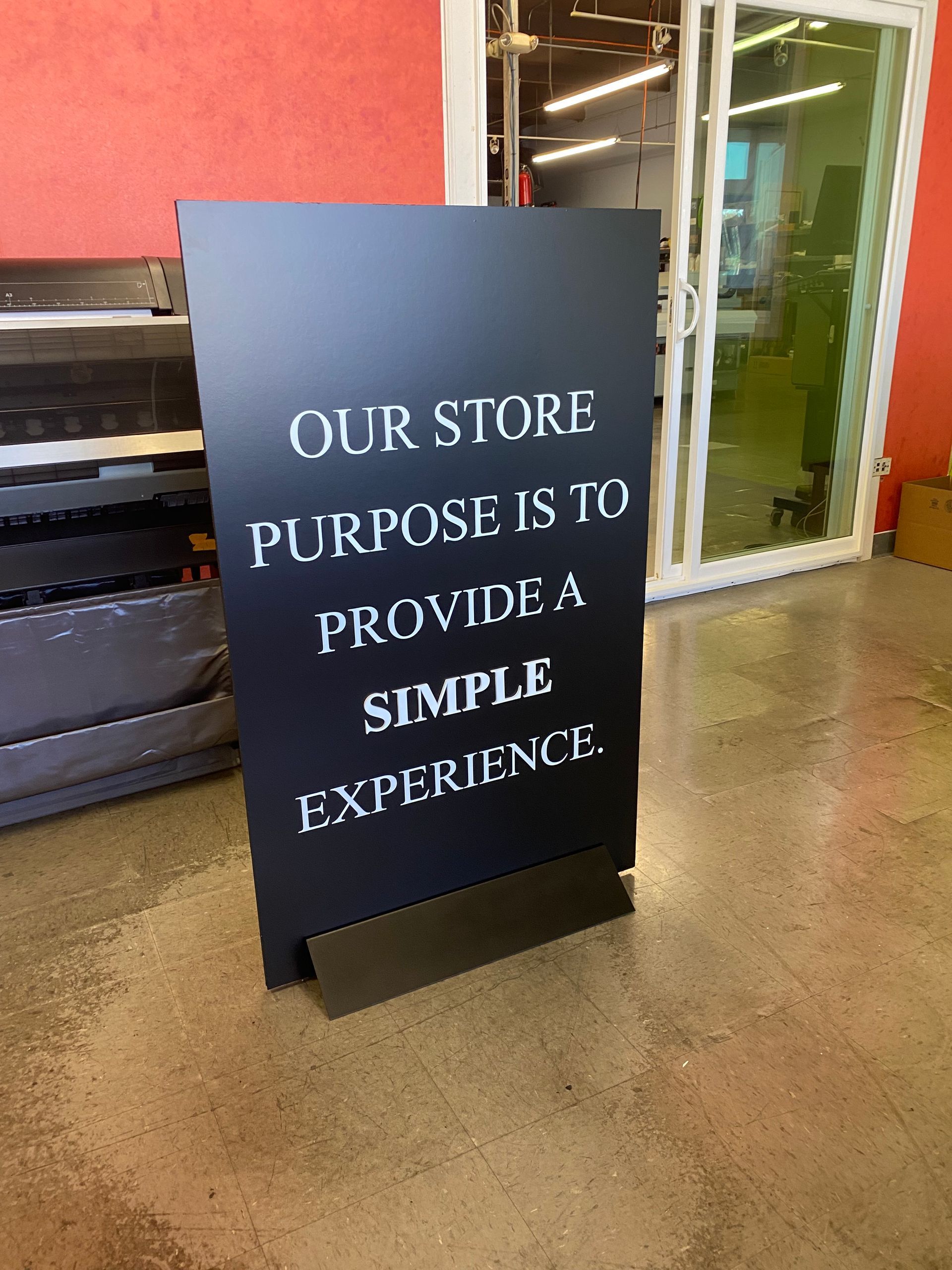 A sign that says our store purpose is to provide a simple experience