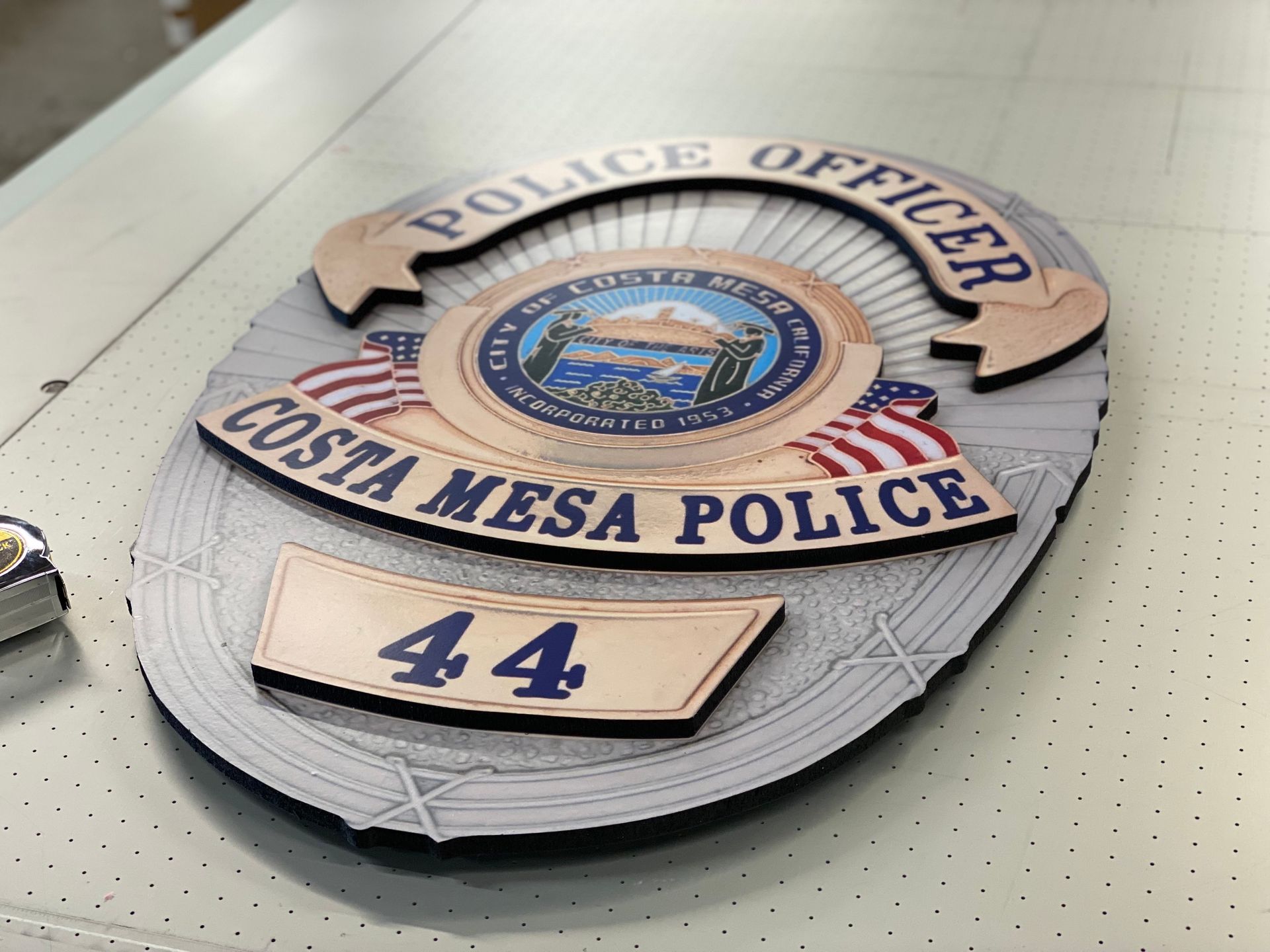 A costa mesa police badge with the number 44 on it