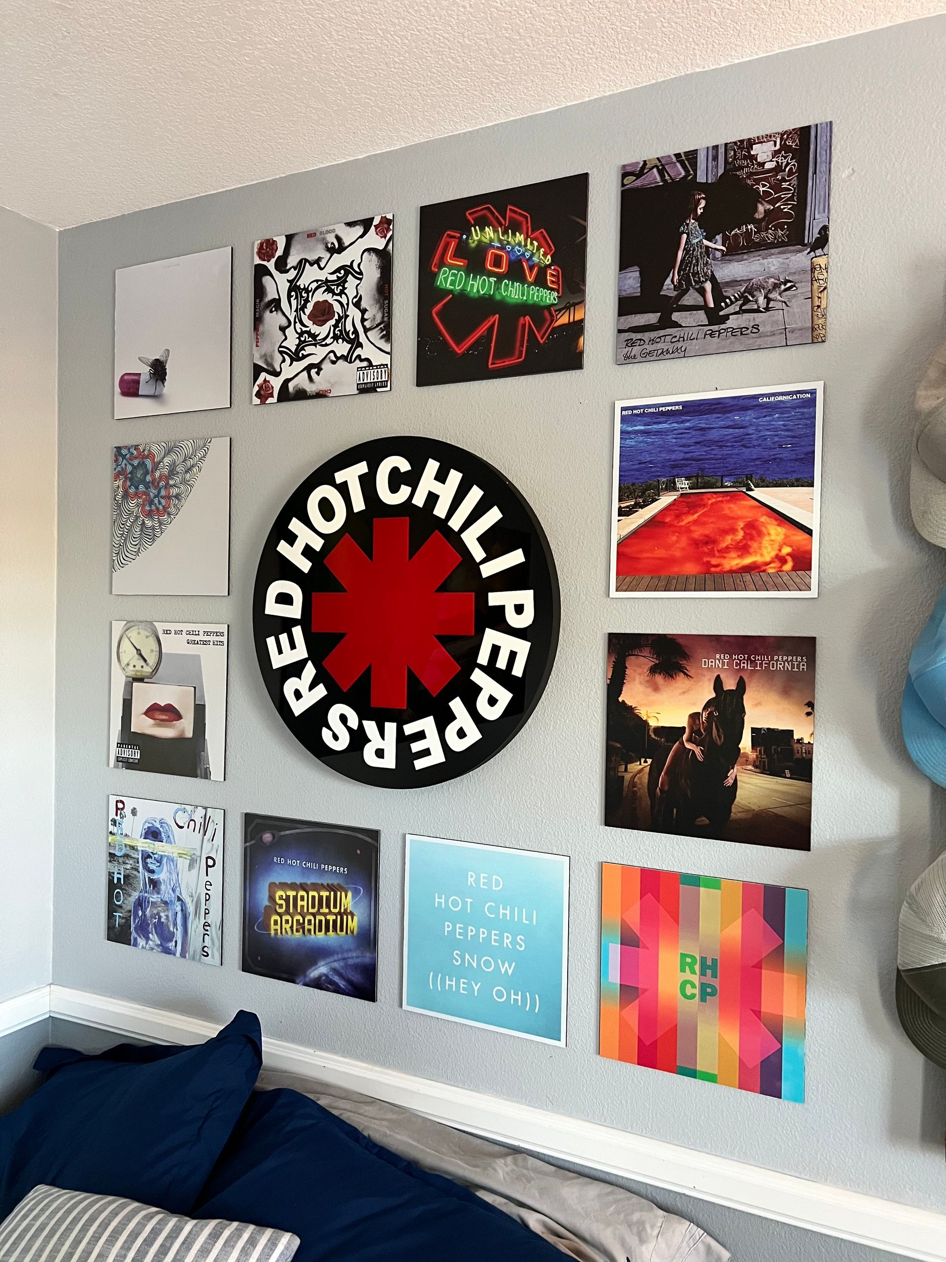 A wall with pictures of red hot chili peppers on it