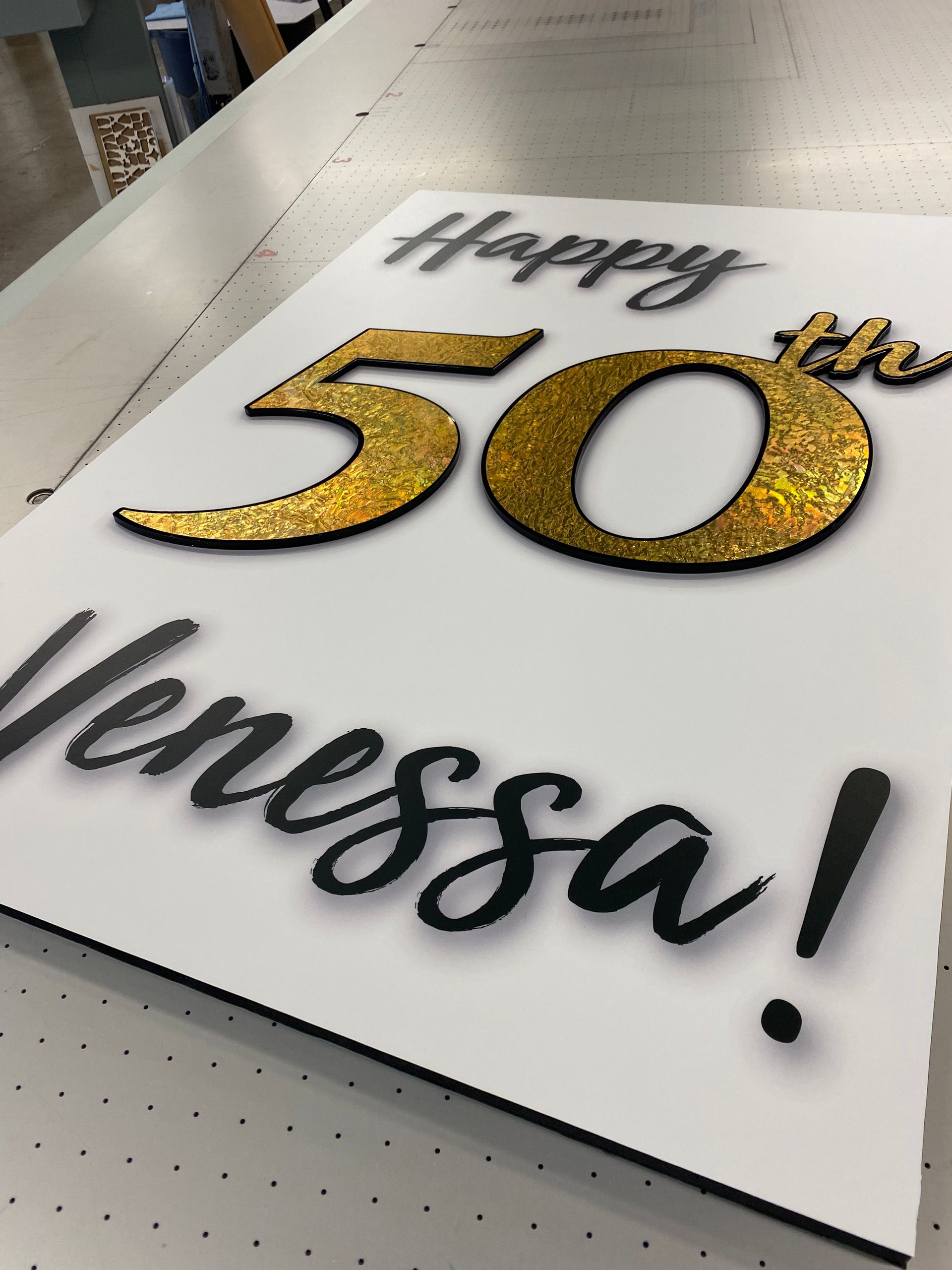 A sign that says happy 50th vanessa on it
