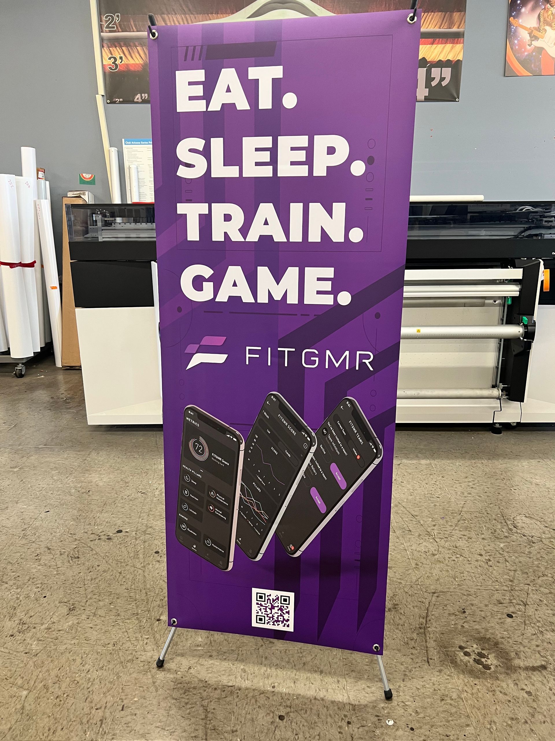A purple banner that says `` eat , sleep , train , game . ''