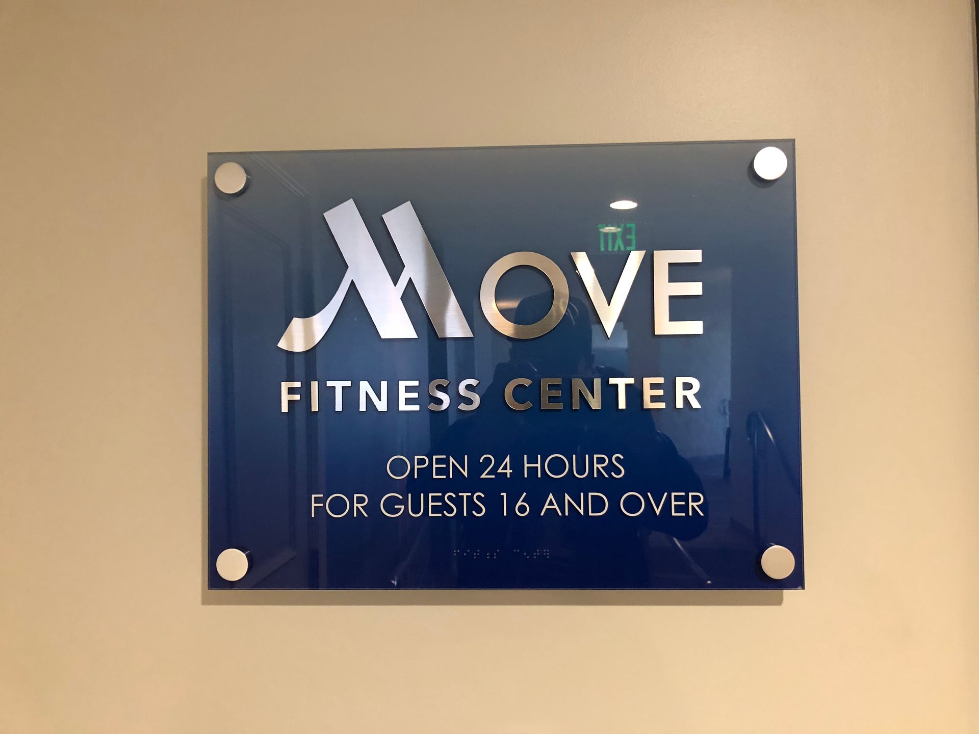 A sign that says move fitness center open 24 hours for guests 6 and over