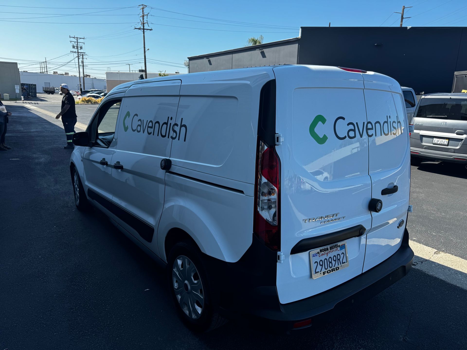 A white cavendish van is parked on the side of the road