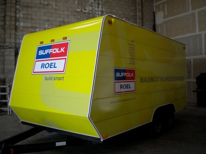 A yellow trailer with suffolk roel written on it