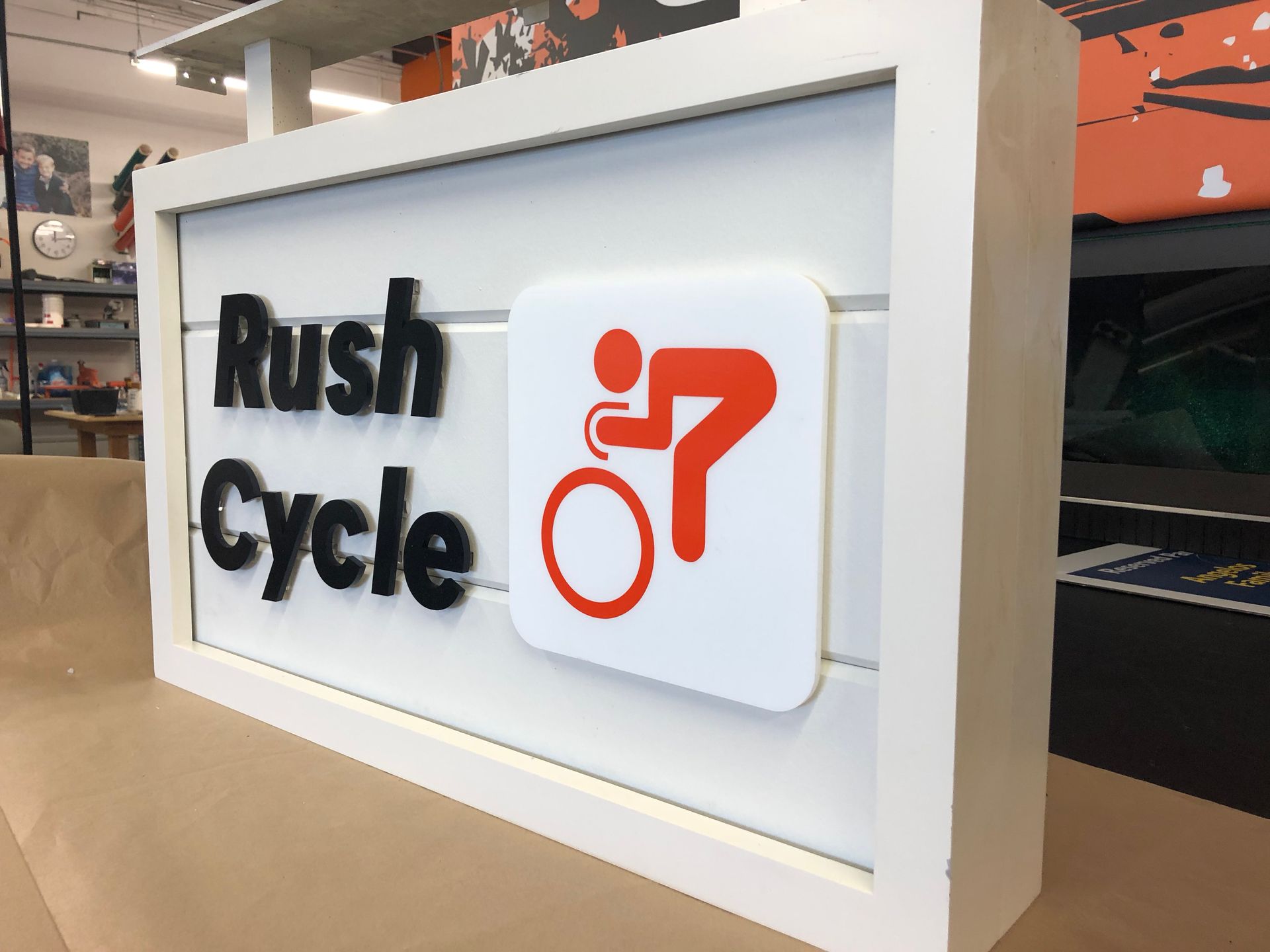 A sign for rush cycle is sitting on a table.