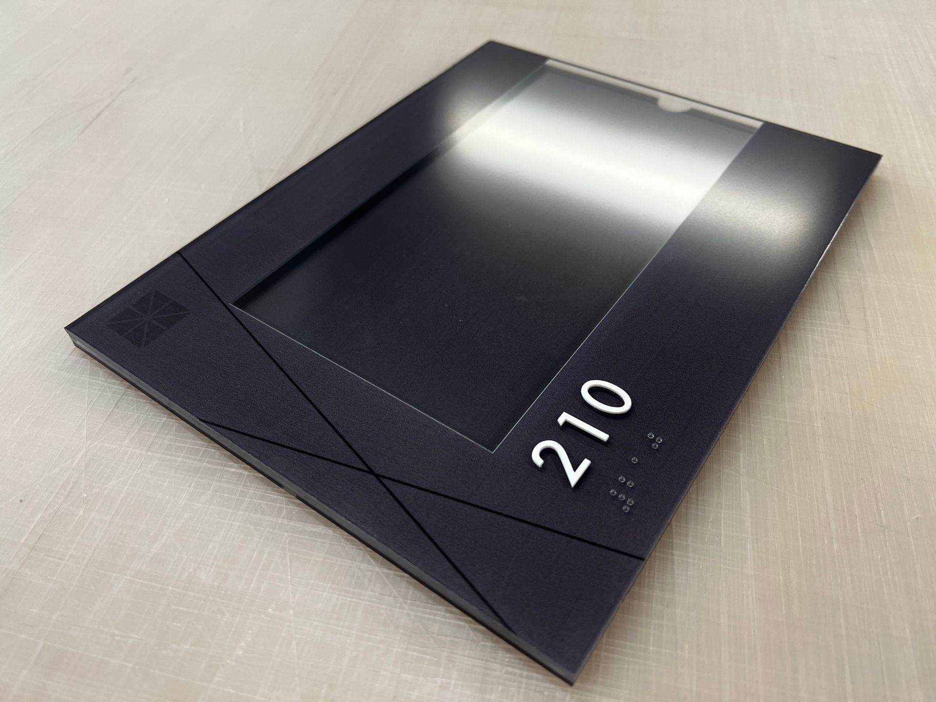 A black sign with the number 210 on it