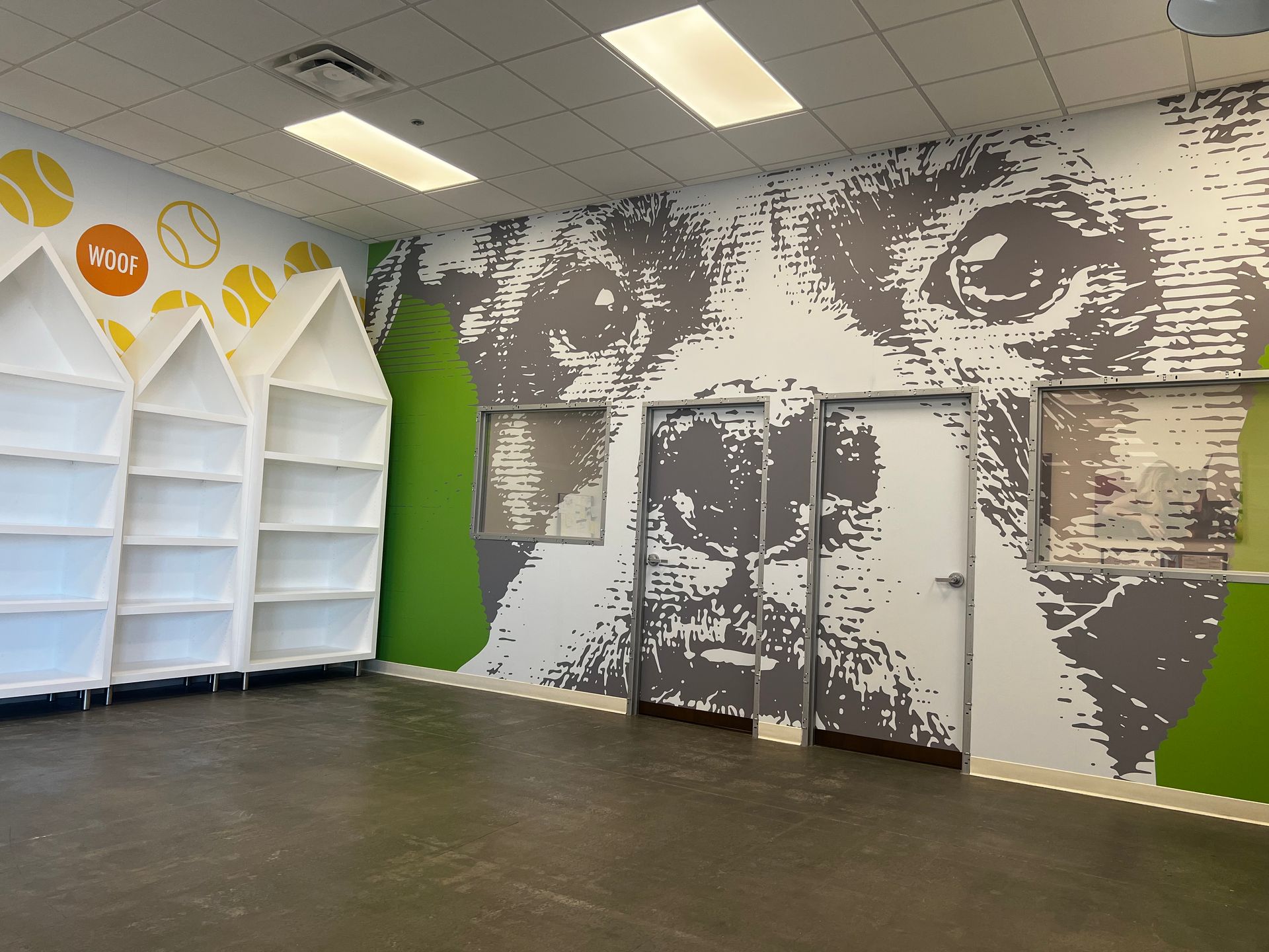 A room with a picture of a dog on the wall.