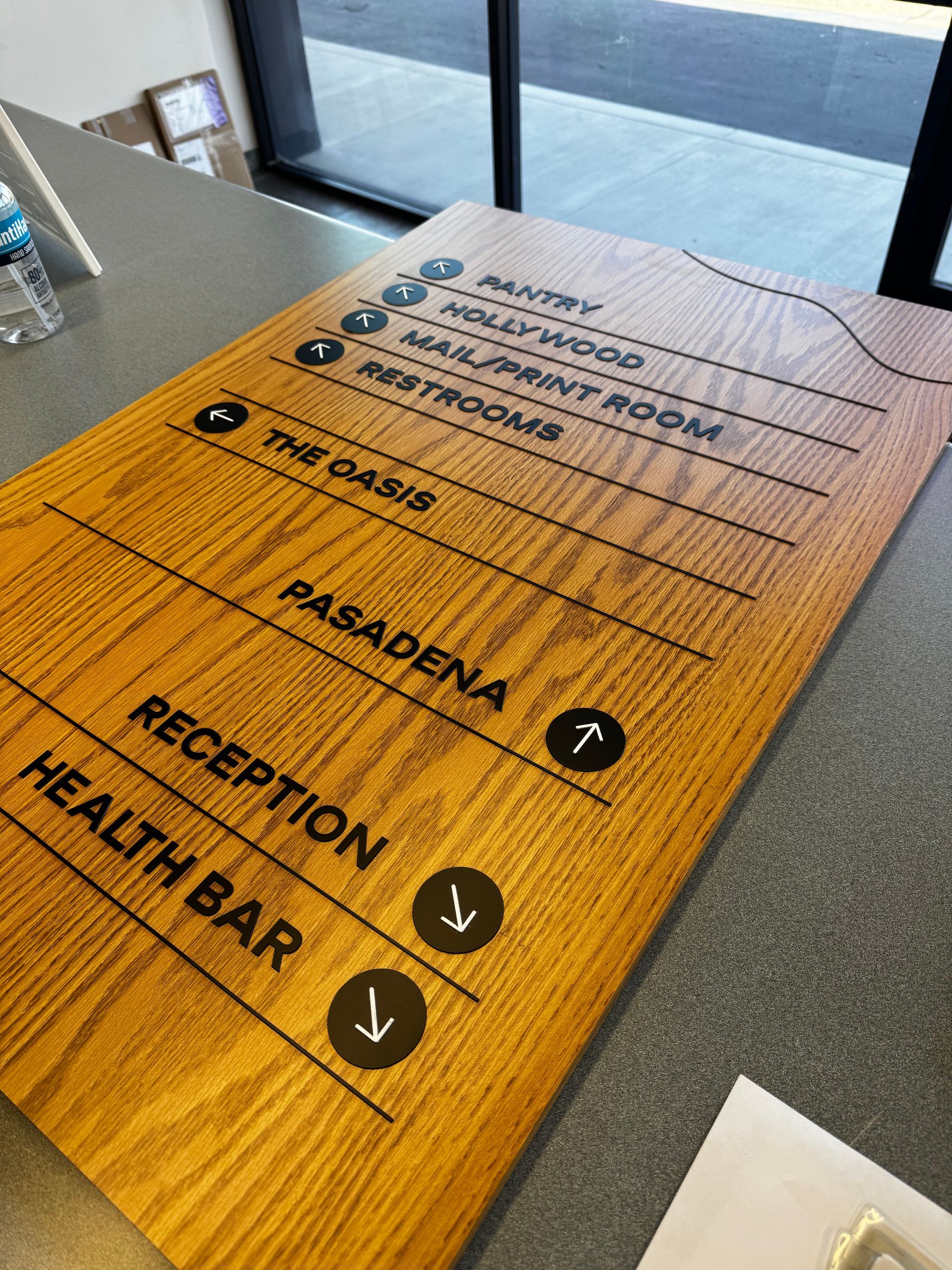 A wooden sign with arrows pointing to the reception and health bar.