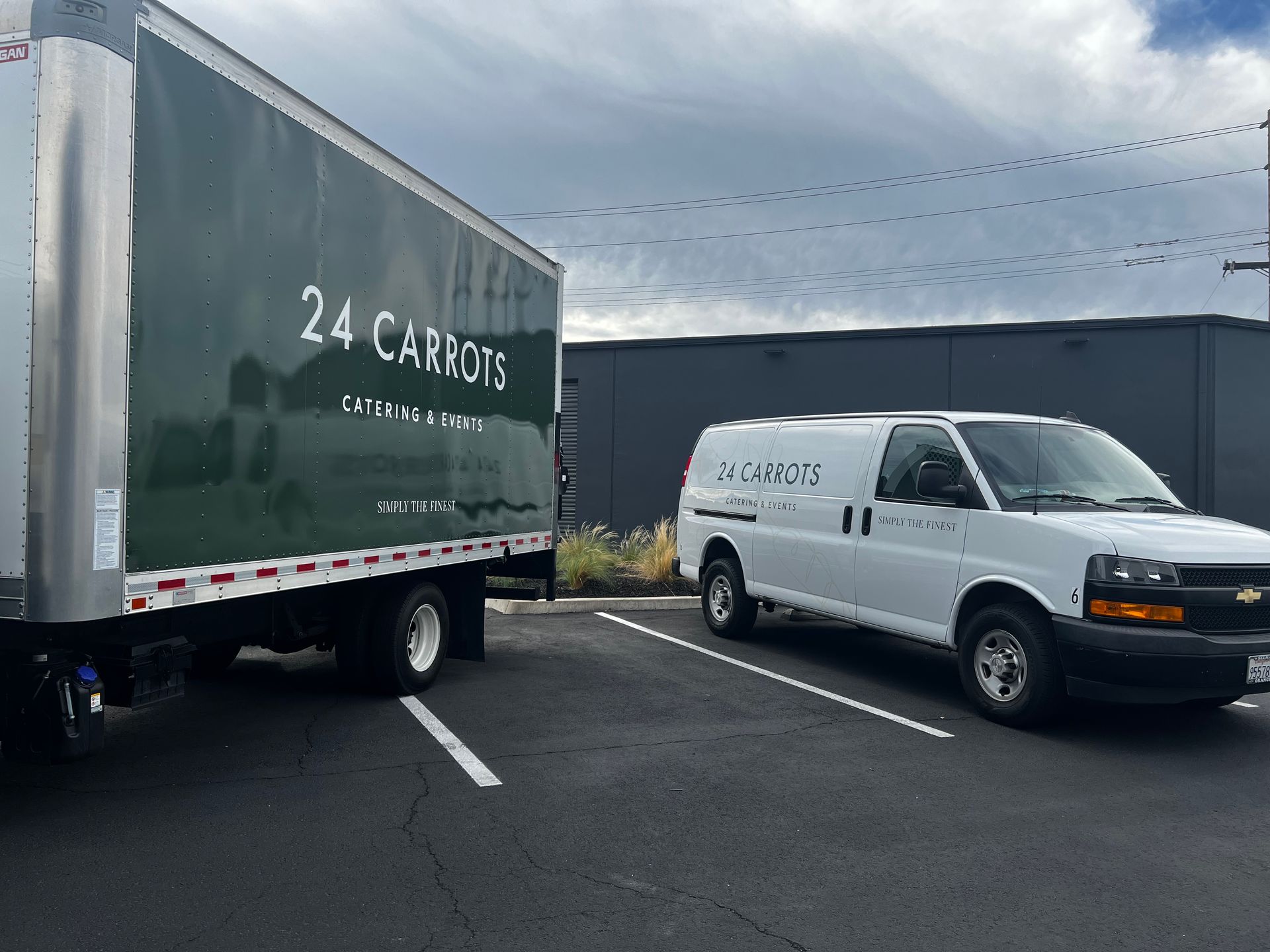 Two vans are parked next to each other in a parking lot.