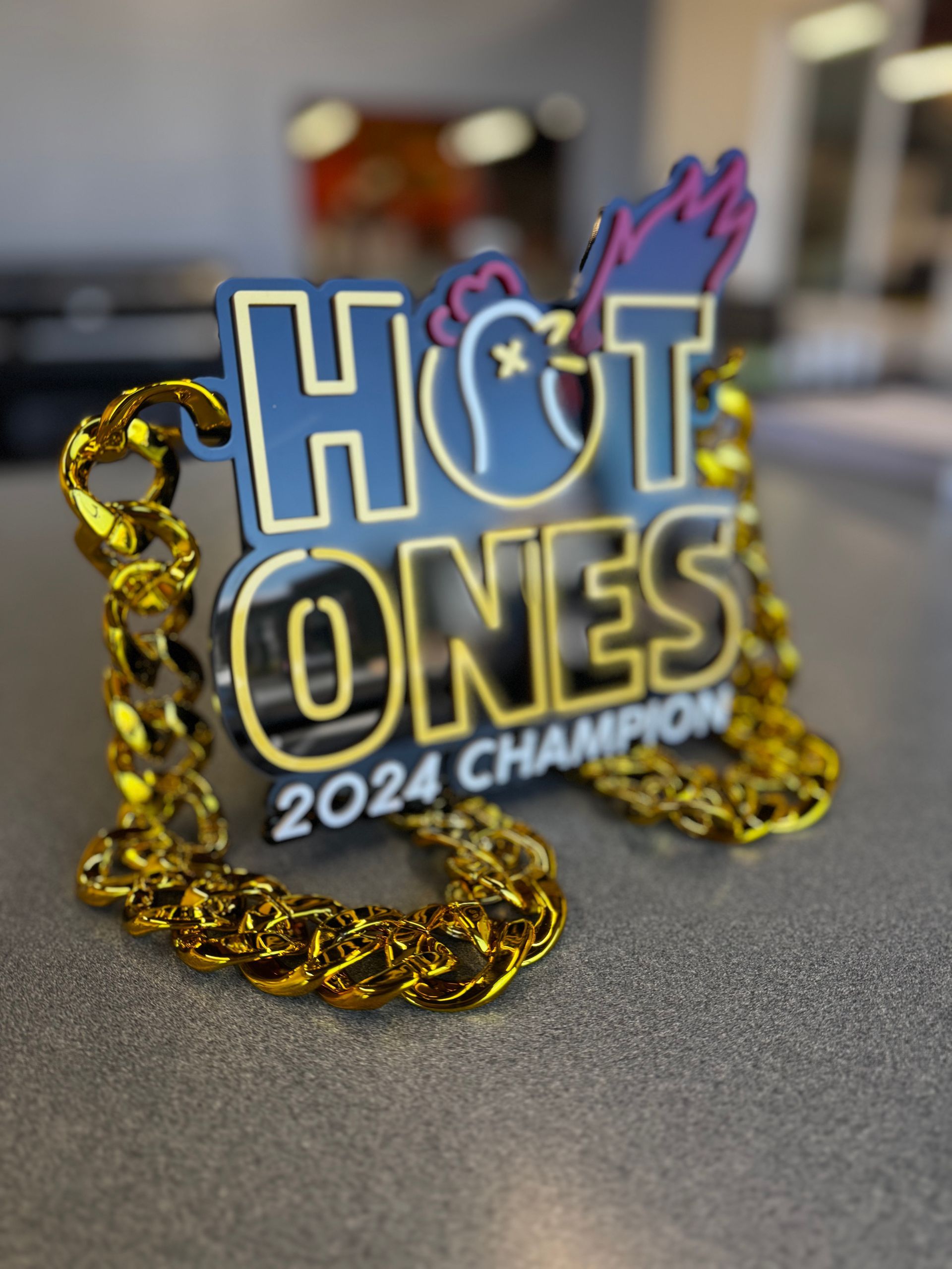 A sign that says hot ones 2024 champion on it