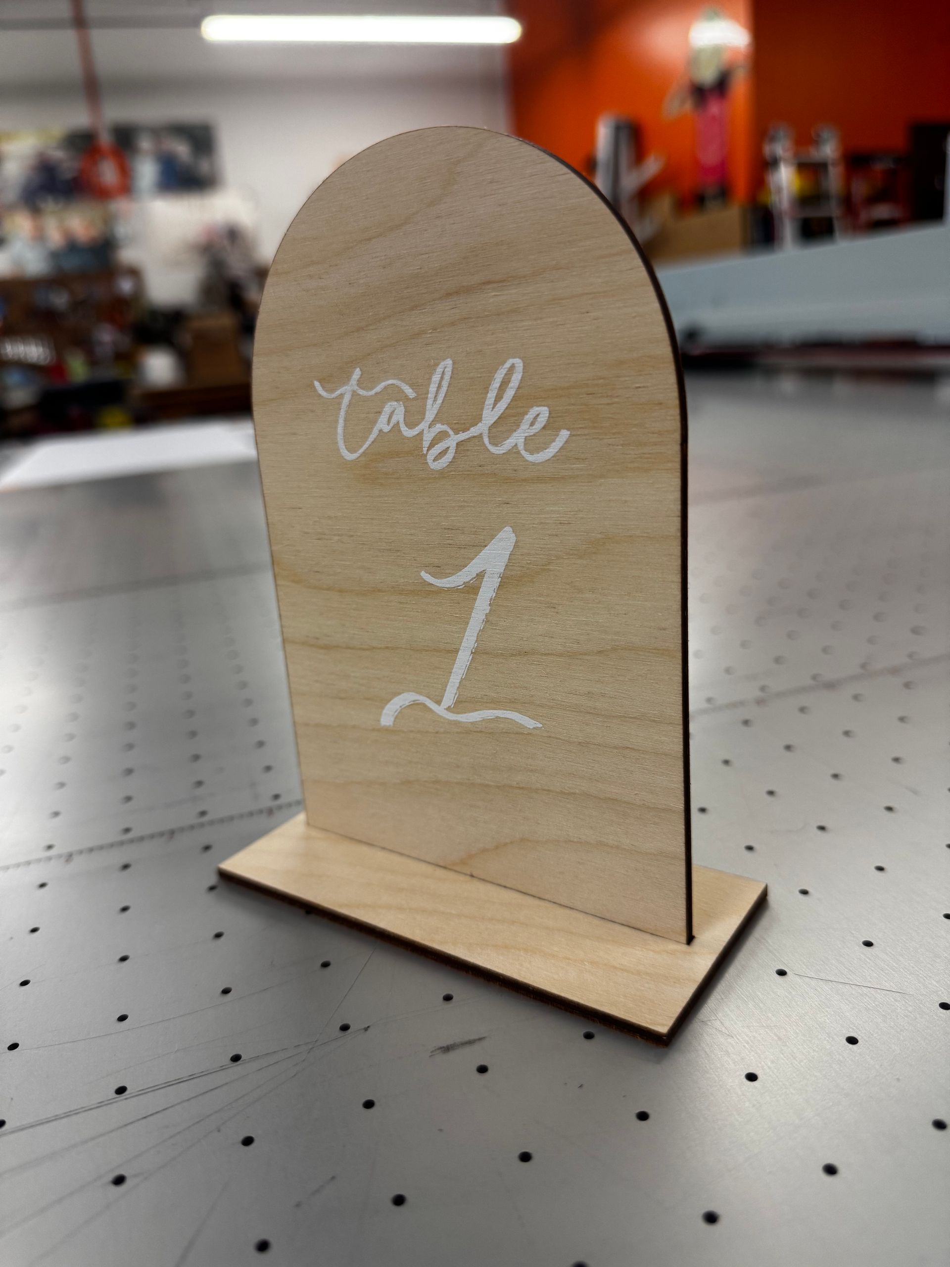 A wooden table number 1 is sitting on a table.