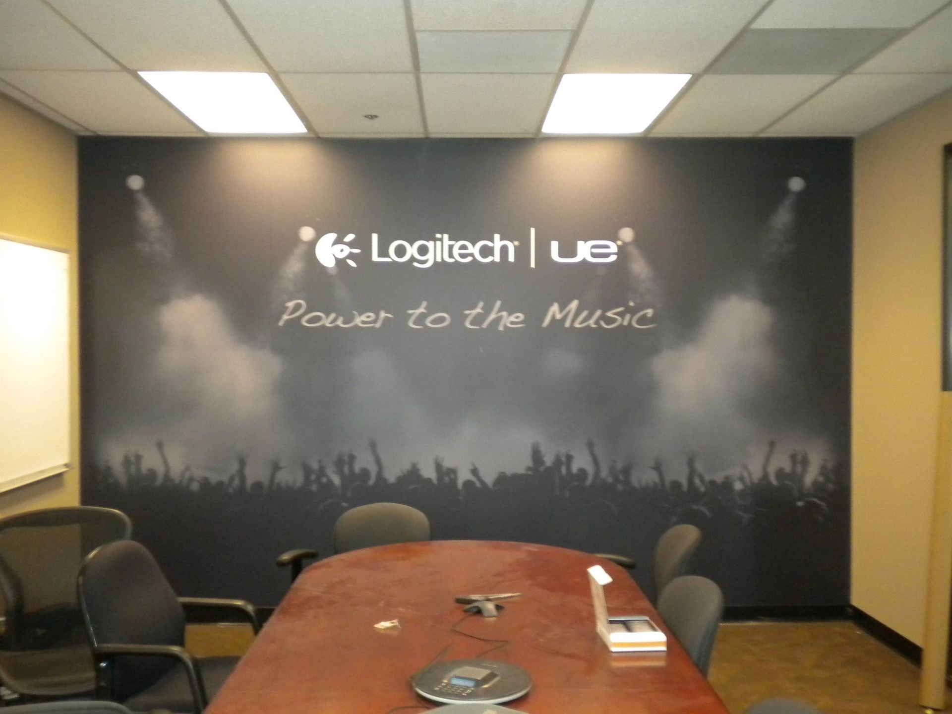 A conference room with a sign that says logitech power to the music