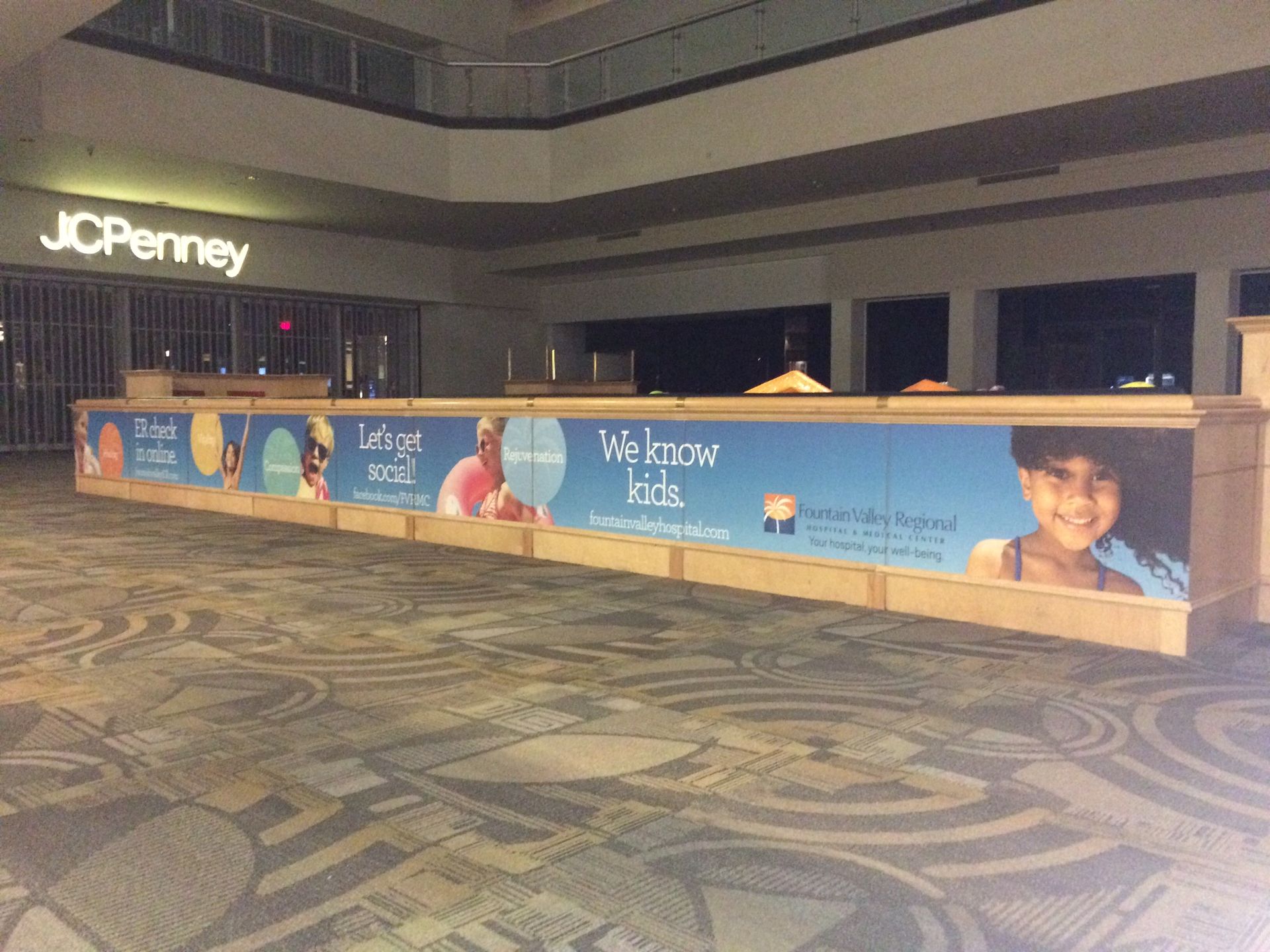 An empty jcpenney store with a sign that says we know kids