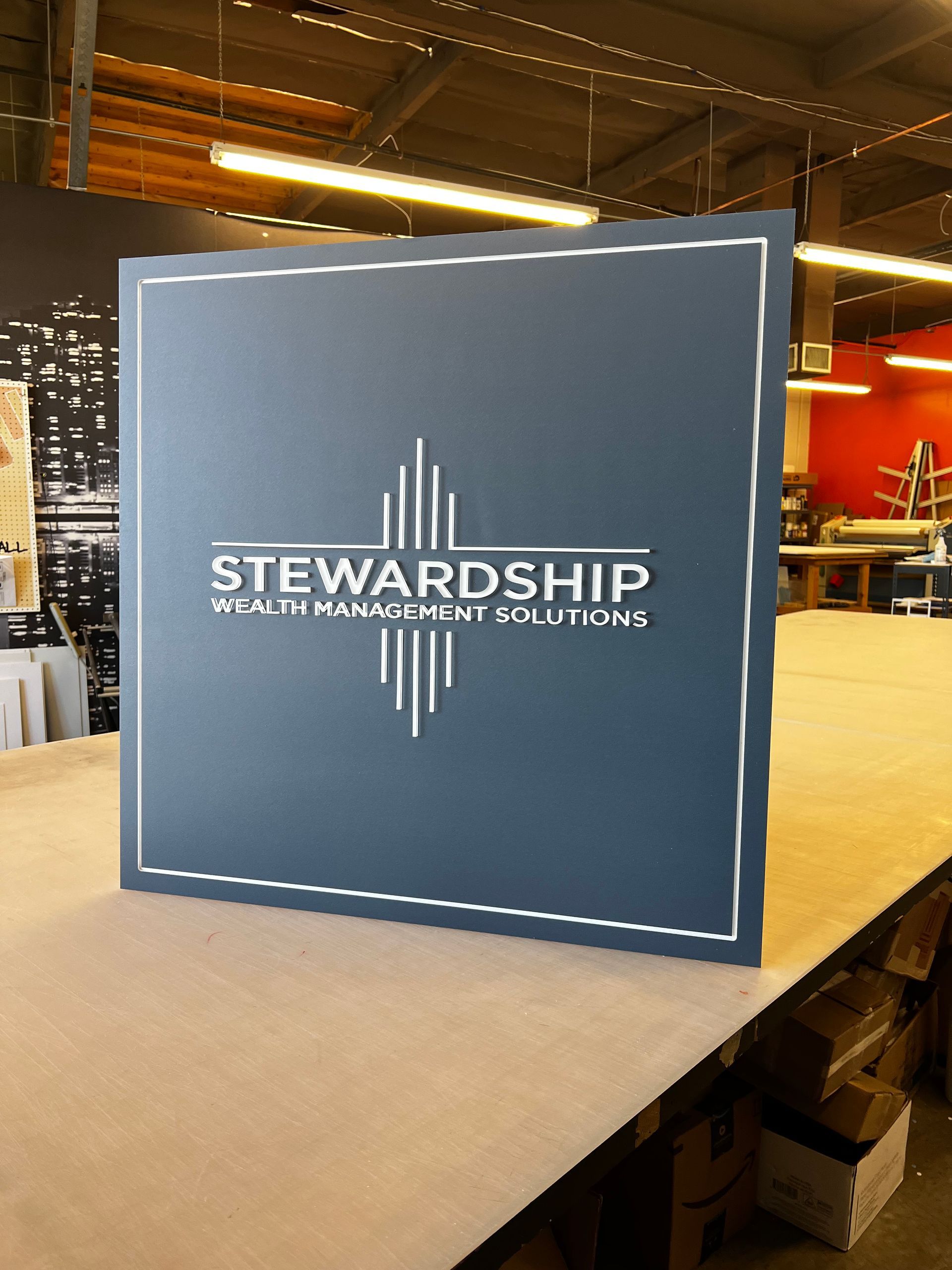 A sign for stewardship sits on a wooden table