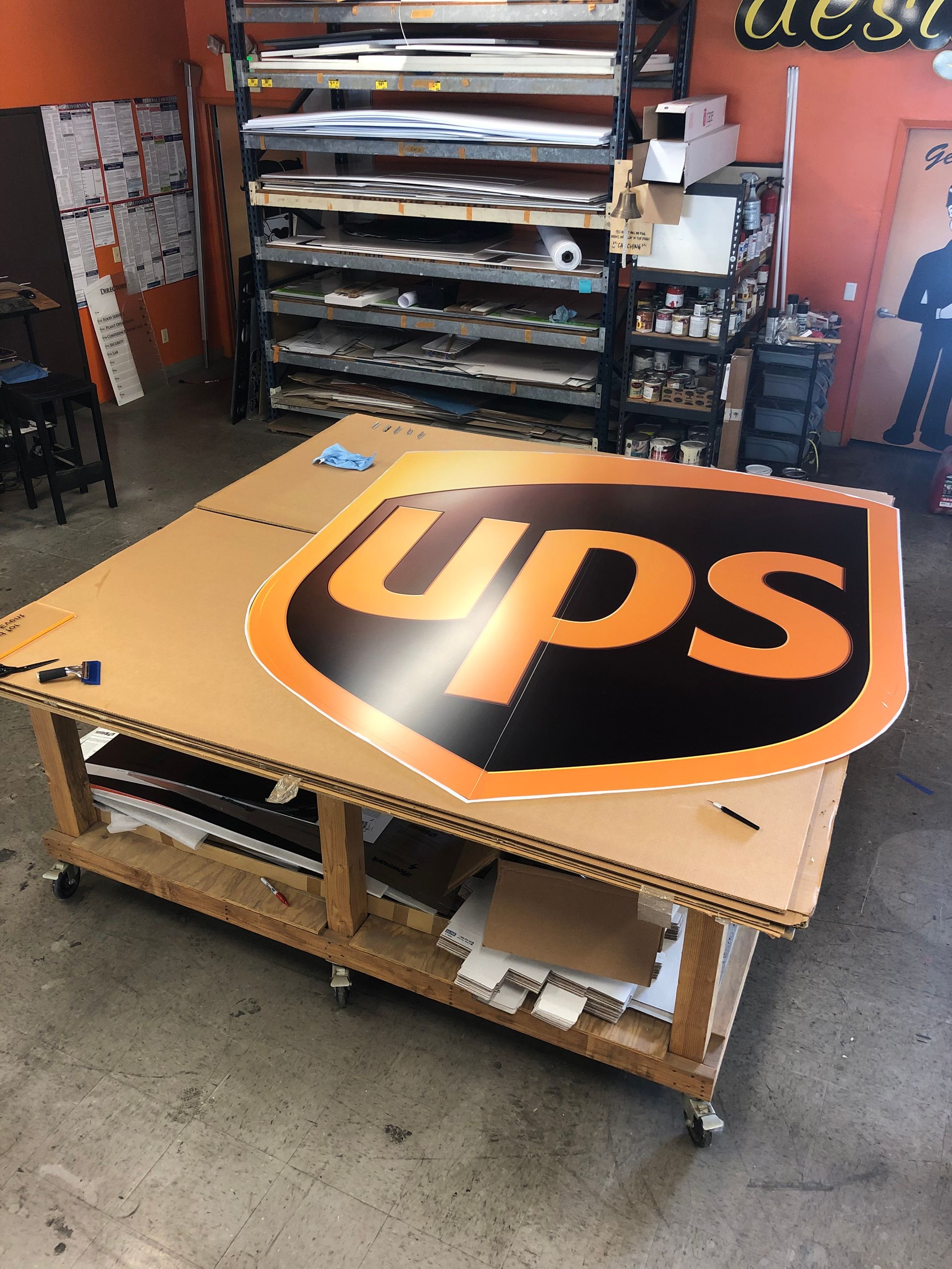 A large ups sign is sitting on a wooden table