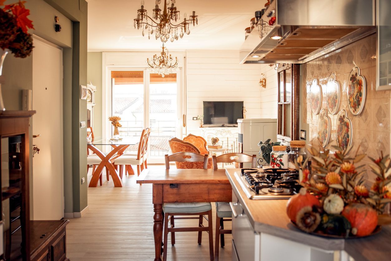 Interior view of a kitchen and dining area with wooden furniture and a chandelier.