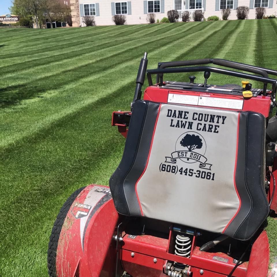 a red lawn mower from dane county lawn care